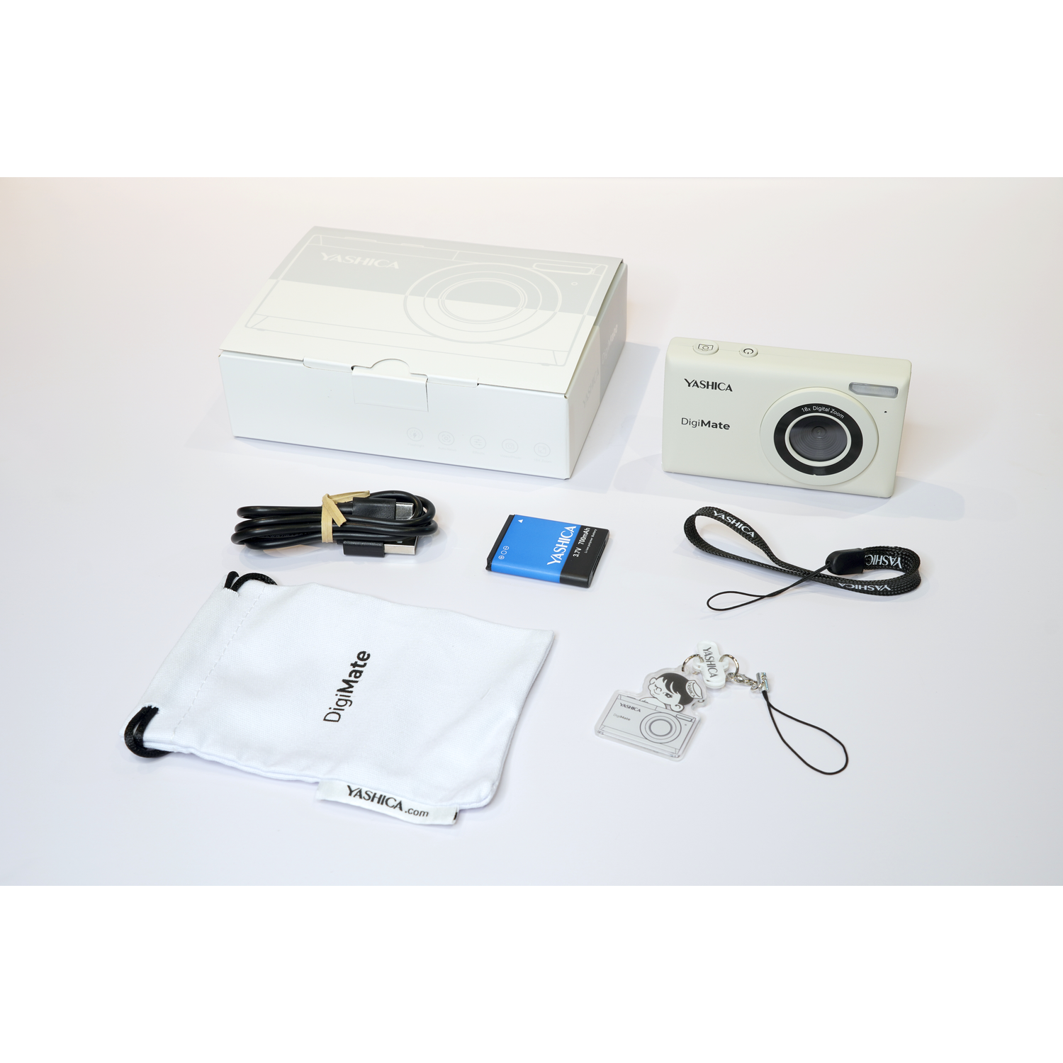 Camera kit with camera, box, accessories, and a carrying bag on a white background.