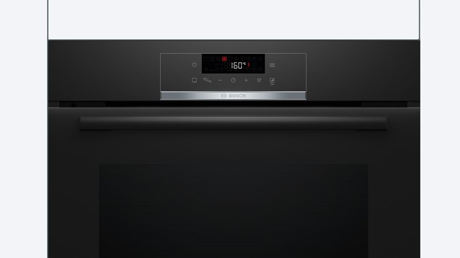 Panel de control de horno negro con pantalla digital y varios botones, sobre fondo claro.