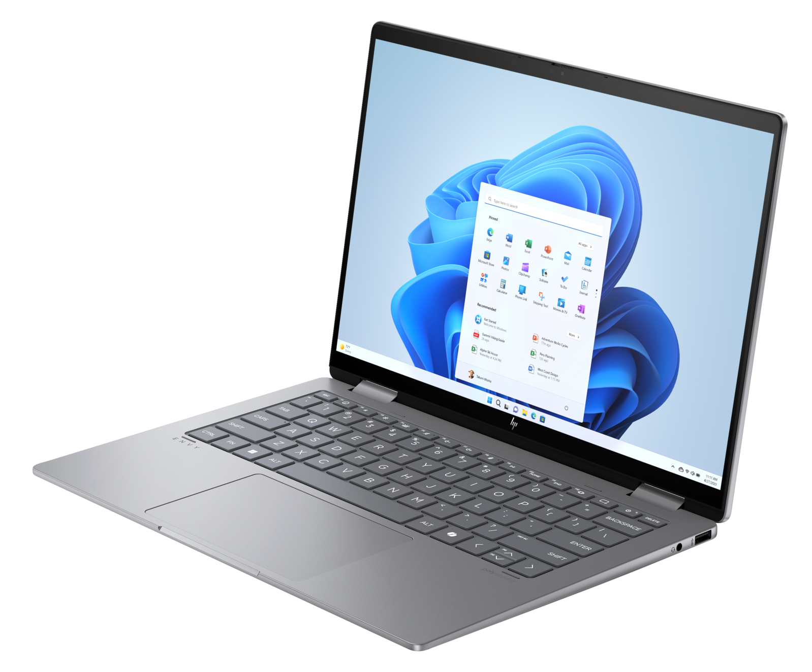 Srebrny laptop, otwarty na biurku, wyświetlający menu start Windows 11. Czarne tło.