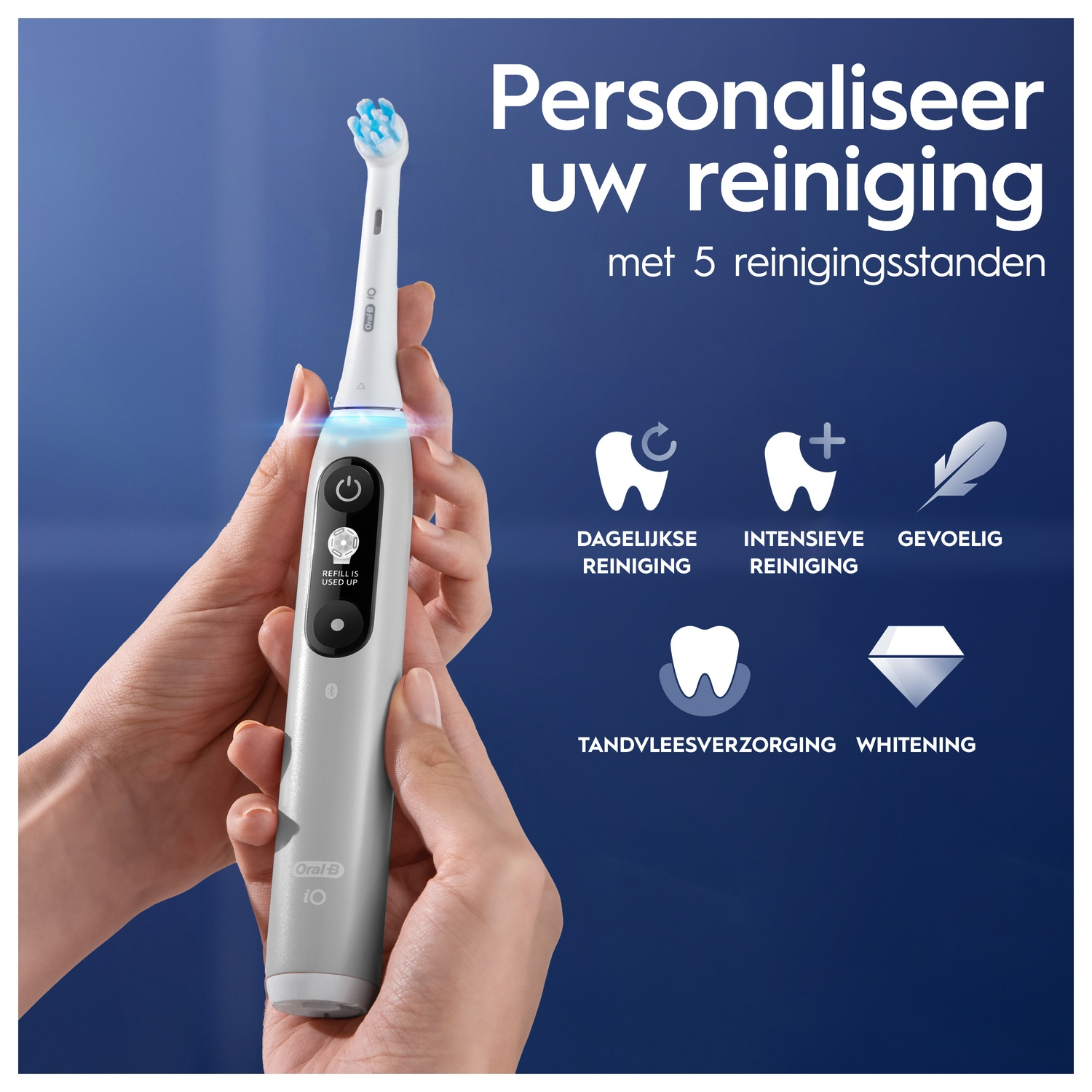 Hands holding white and gray electric toothbrush with blue bristles. Text and icons on the right.