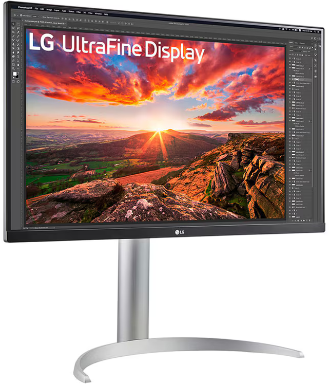 Egy LG UltraFine Display monitor naplementét mutat egy tájon, ezüst állványon.