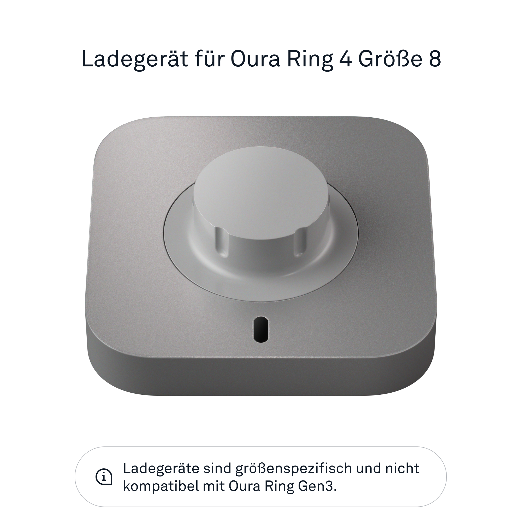 Eine silberne Ladestation für einen Oura Ring 4. Das Gerät hat einen zentralen Knopf und eine kleine LED.
