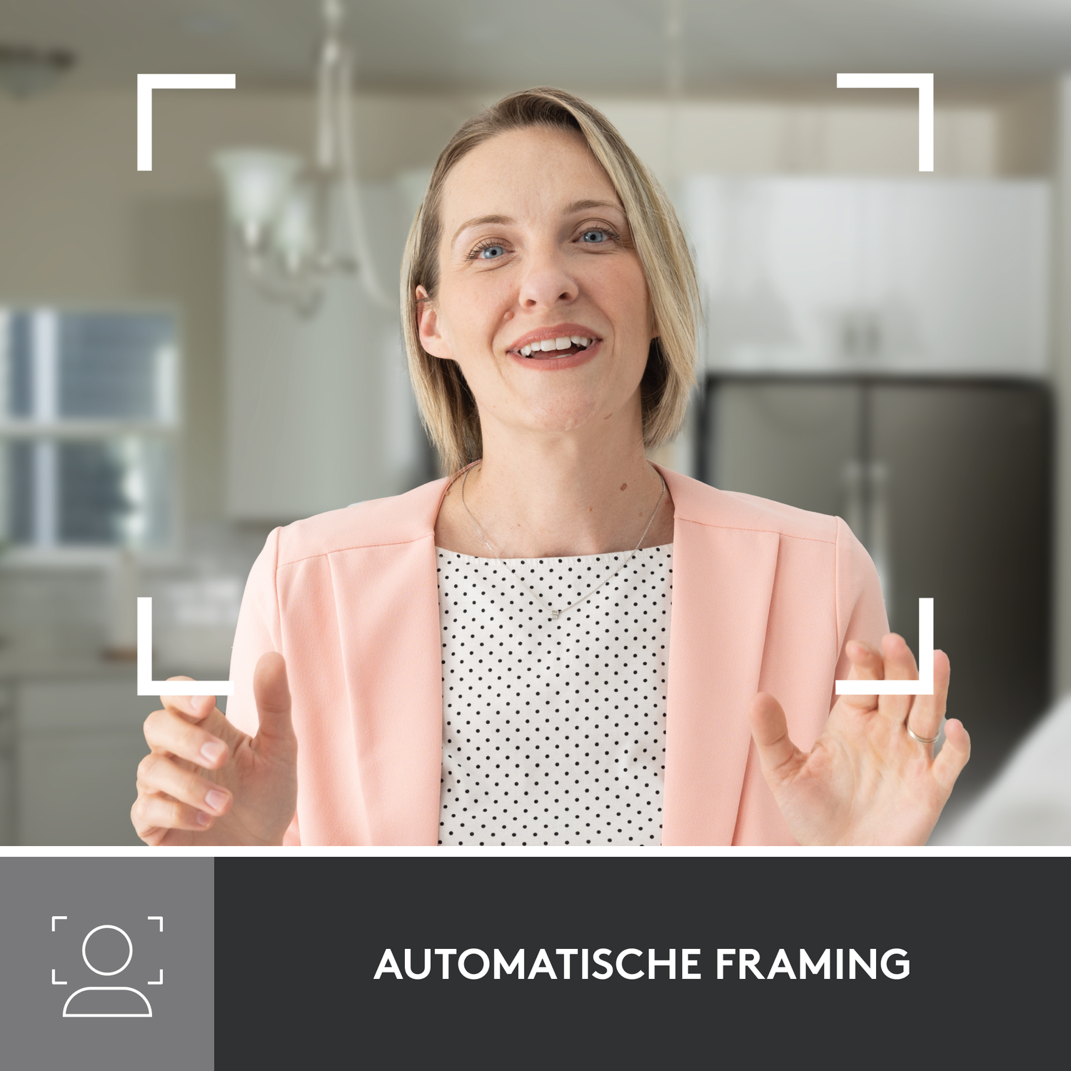 Woman in a pink jacket framed by focus boxes, a kitchen background, automatic framing.