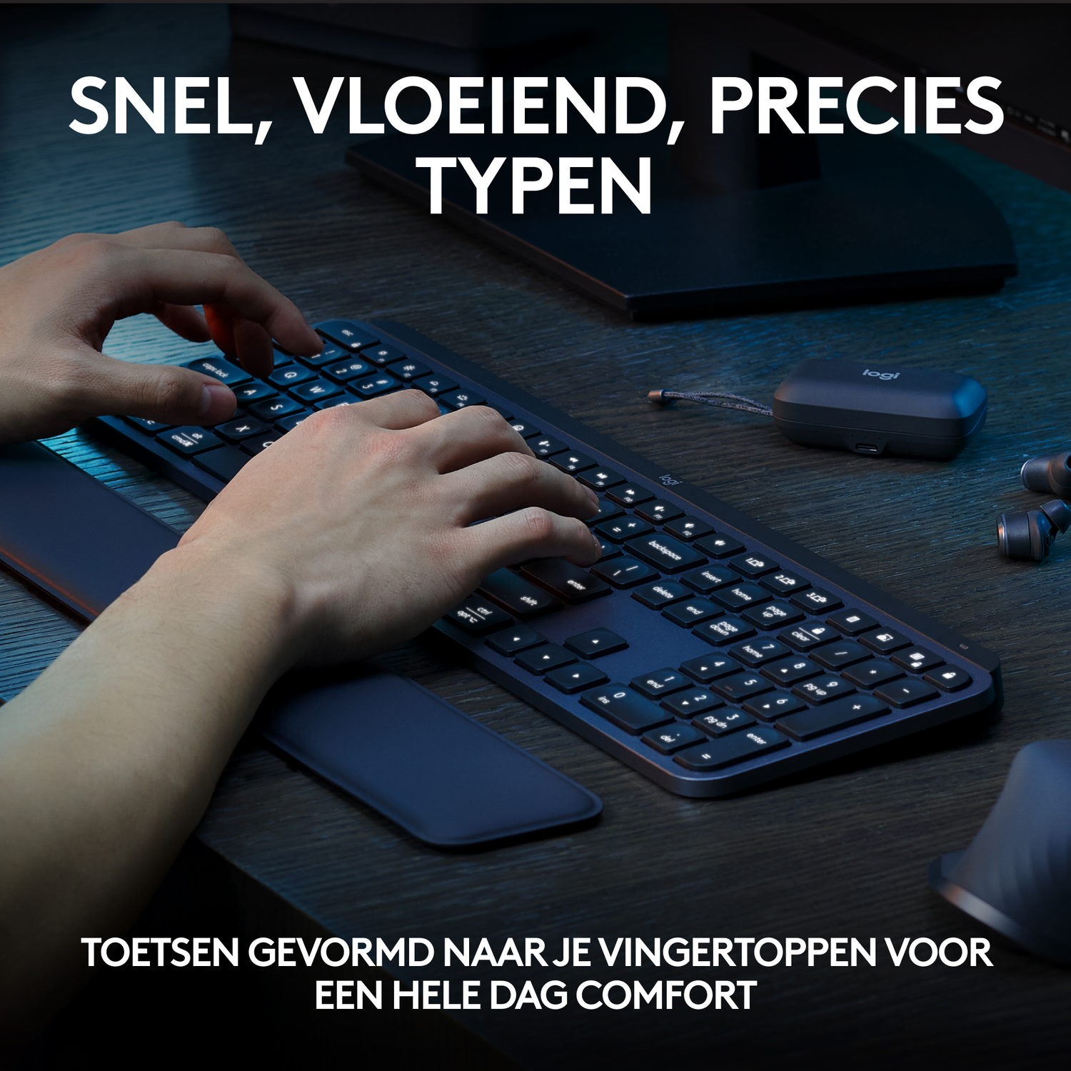 Person typing on a dark keyboard with a blue wrist rest, and a black screen in the background.