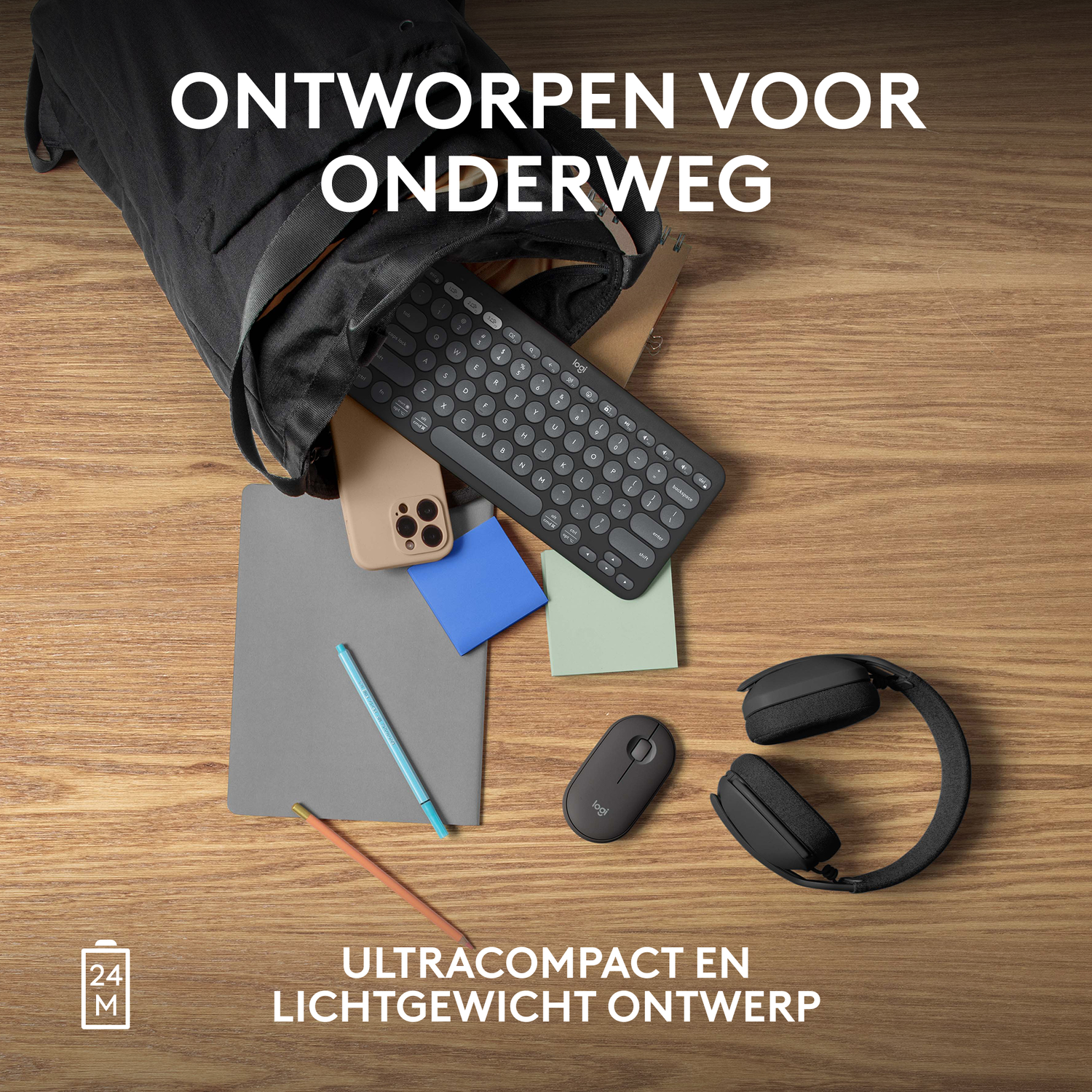 A black backpack with a keyboard, phone, mouse, notepad, pencil, and headphones, all on a wooden table.