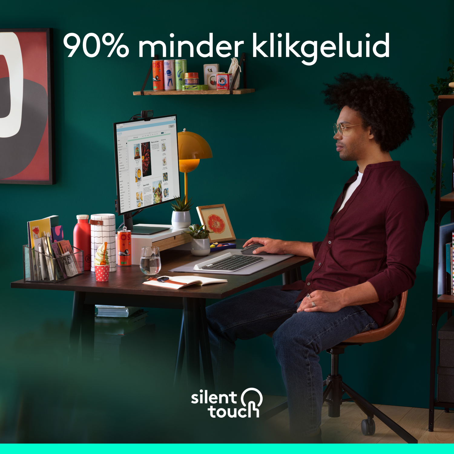 A man sits at a desk with a monitor. Text states 90% less clicking noise.
