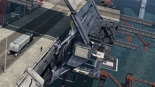 Een luchtfoto van een stad, met een brug en een oplegger op de weg.