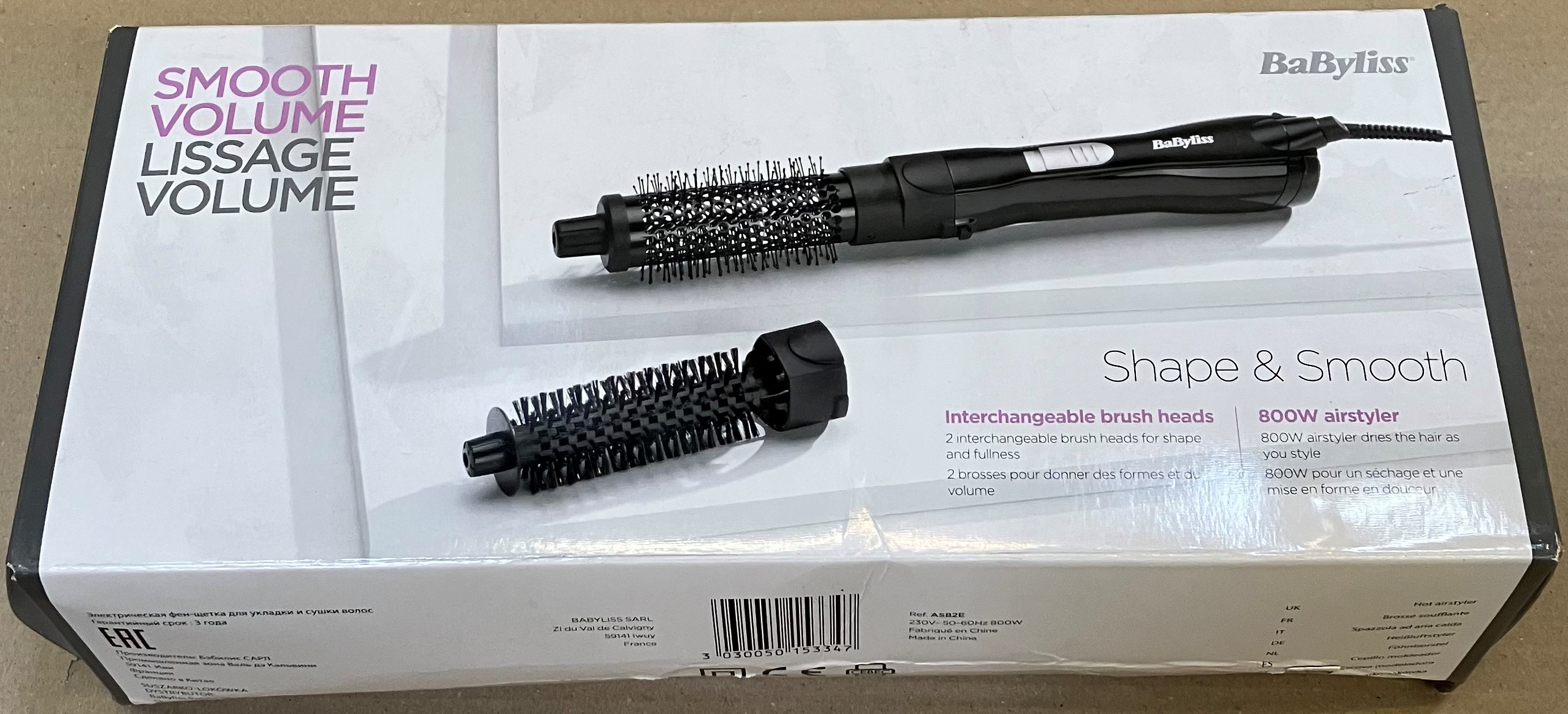 Pudełko z urządzeniem do stylizacji włosów i dwiema wymiennymi głowicami szczotkowymi.