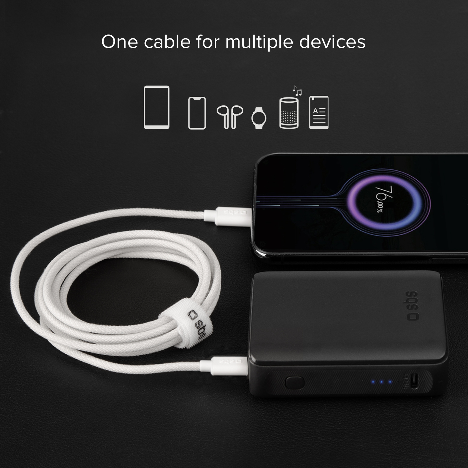 A black power bank charging a phone and another device, with a white cable.