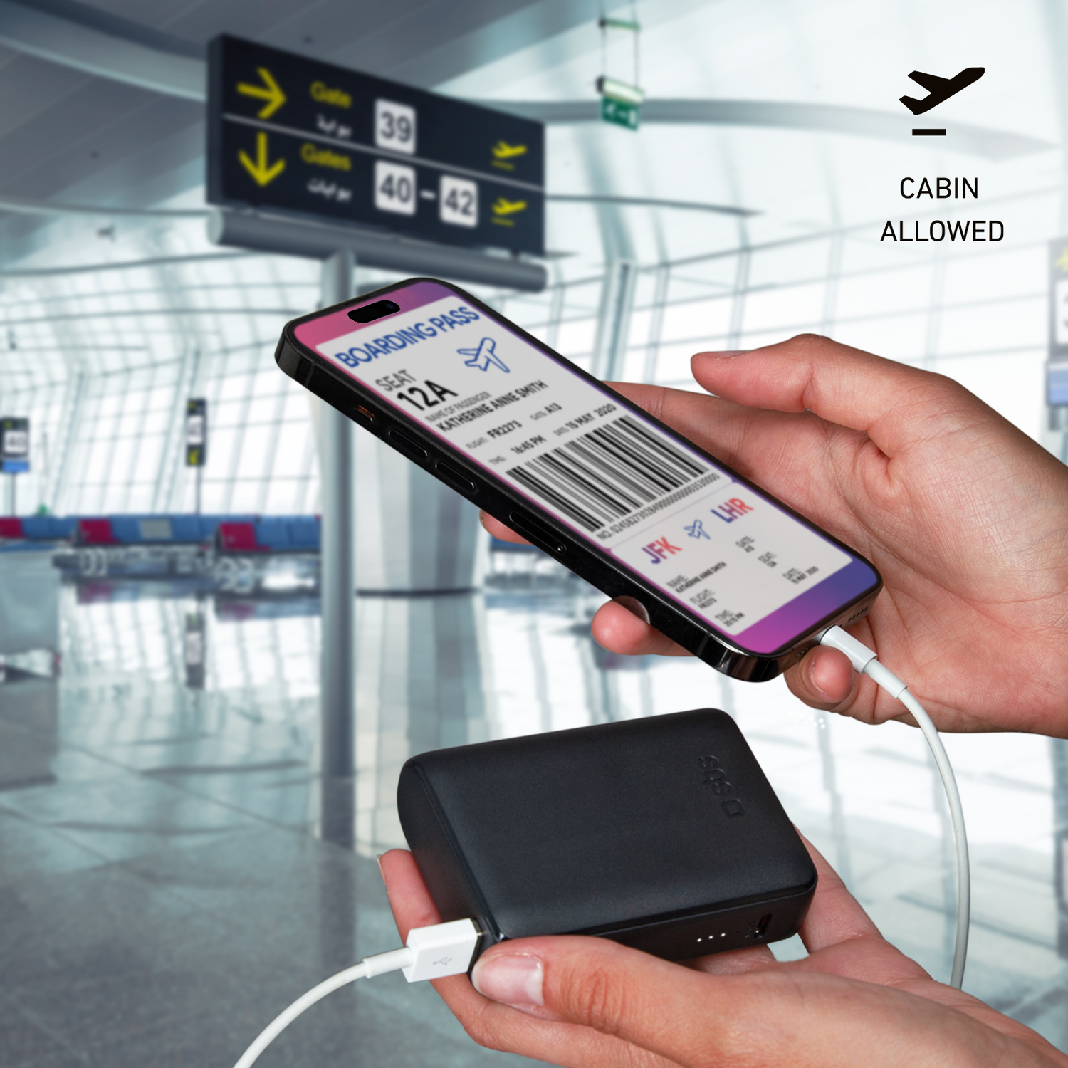 Hands holding phone with boarding pass screen, connected to a black portable charger.