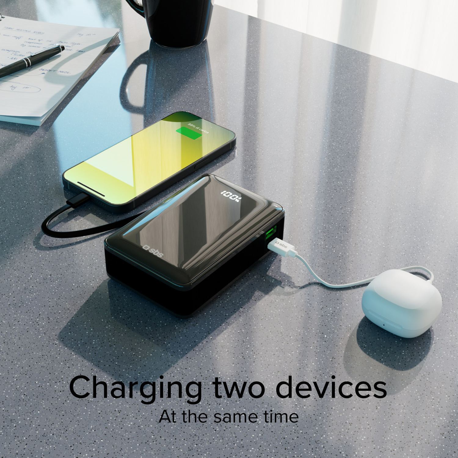 A black power bank is charging a phone and a white small device.