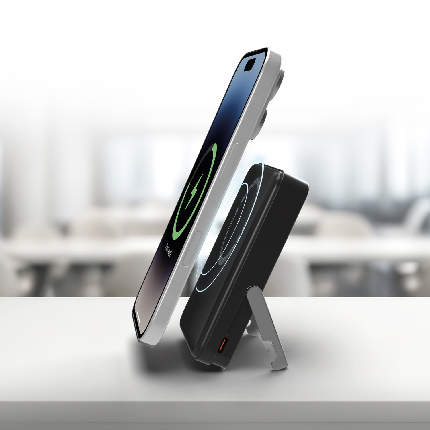 A phone charging on a black wireless charging stand, on a white surface.