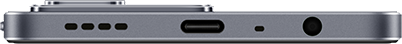 Közelkép egy telefon alsó széléről. Több lyuk, USB-C port és fejhallgató-csatlakozó található rajta.