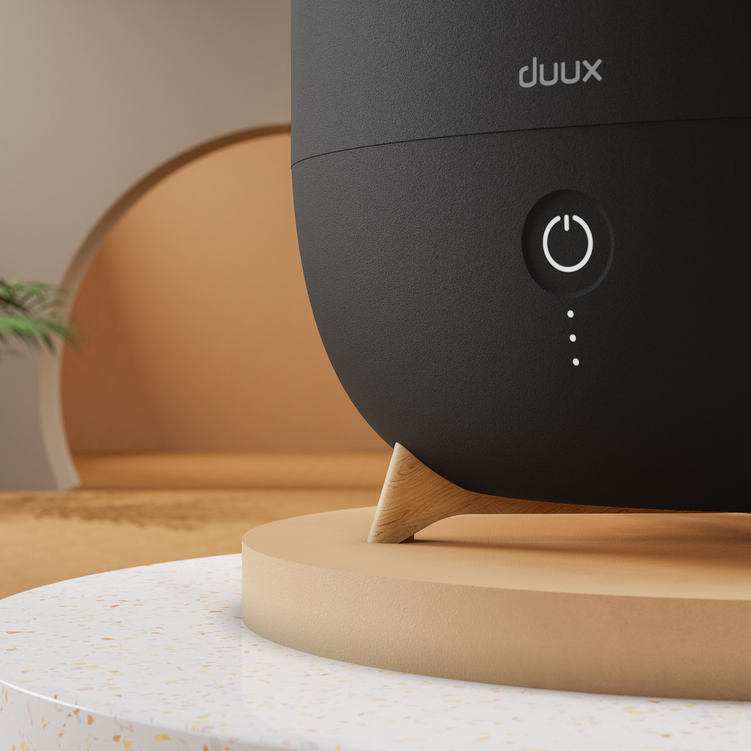Close up of a black duux humidifier with a power button and indicator lights.
