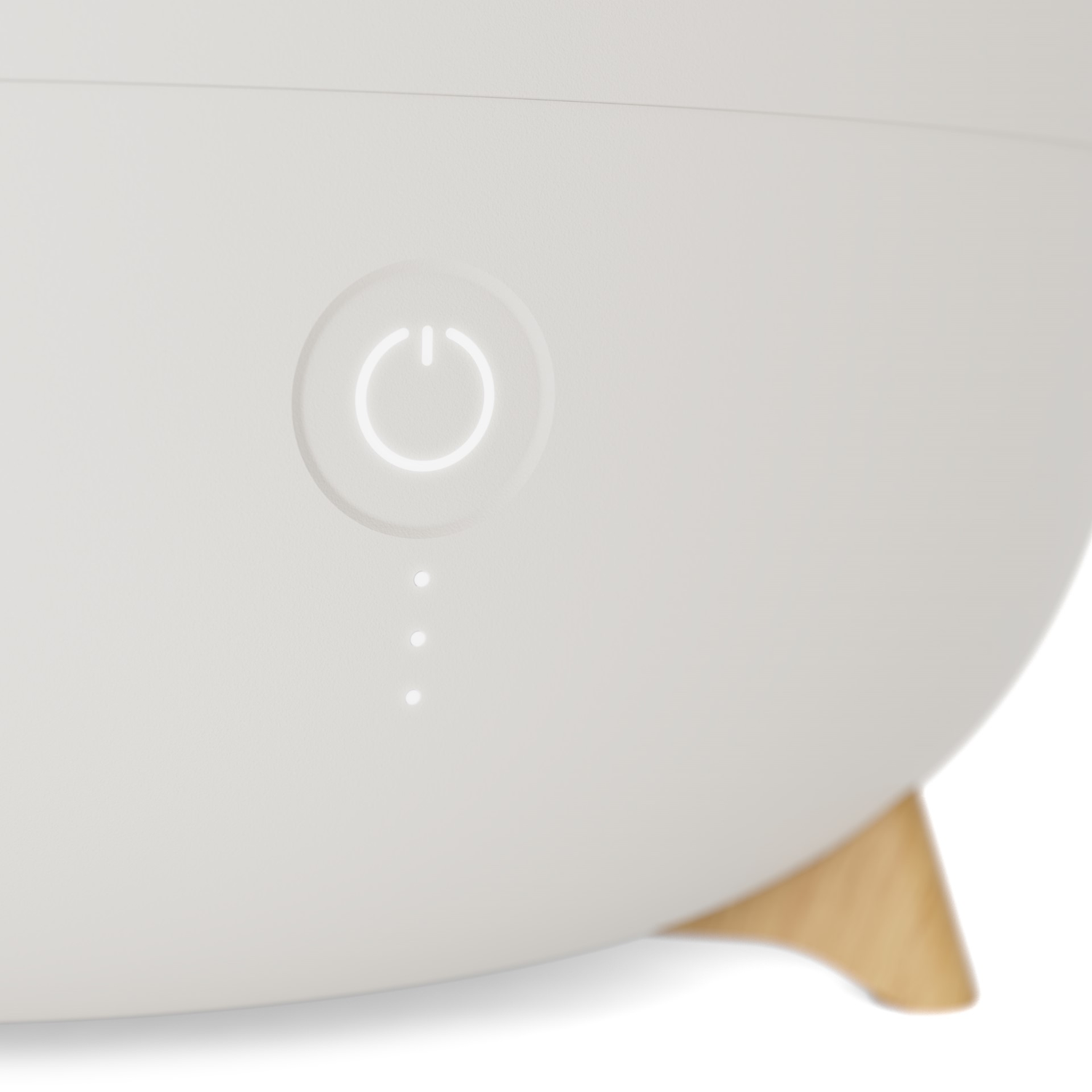 A white humidifier with a power button and indicator lights.