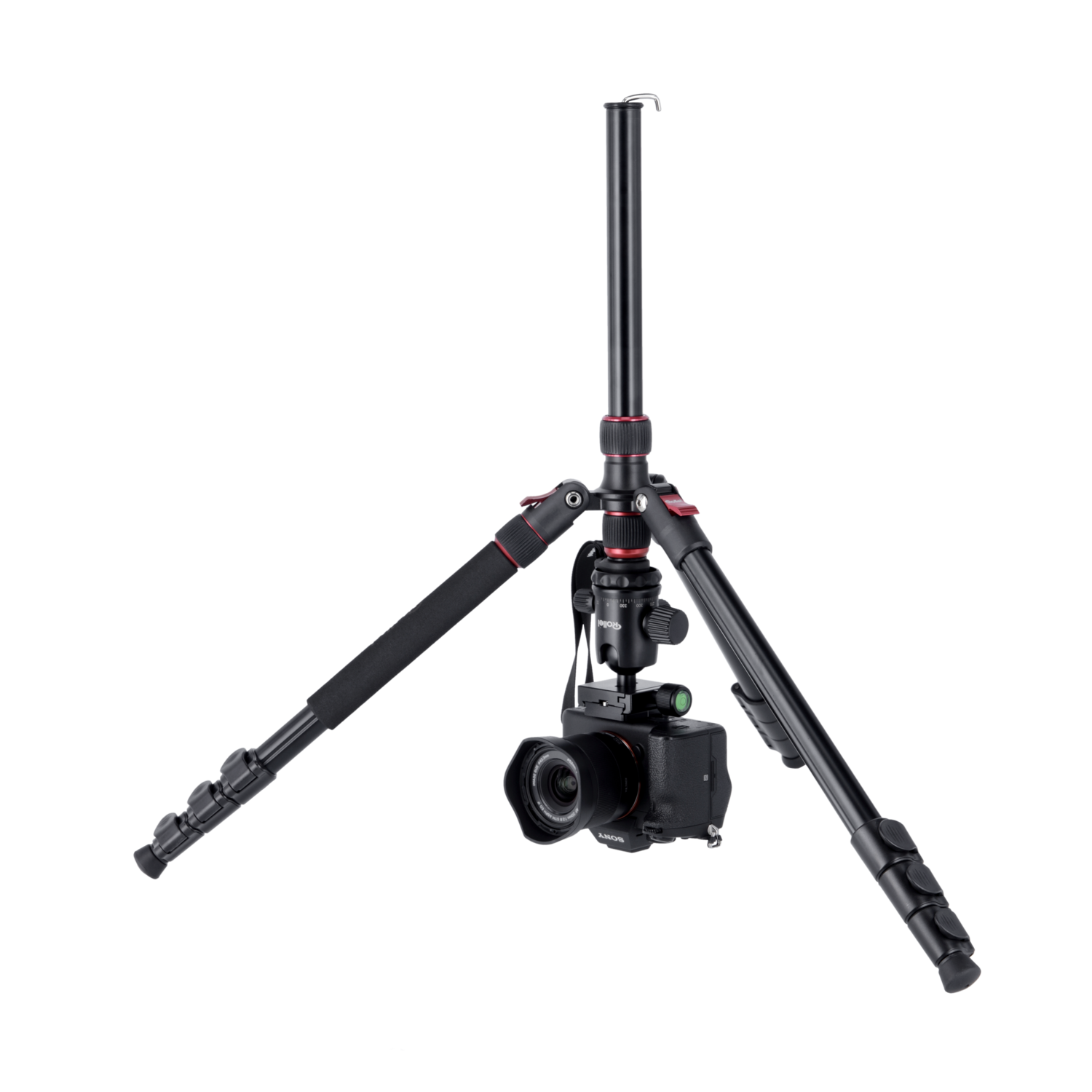 A camera is mounted on a tripod. The tripod has three legs and a central pole.