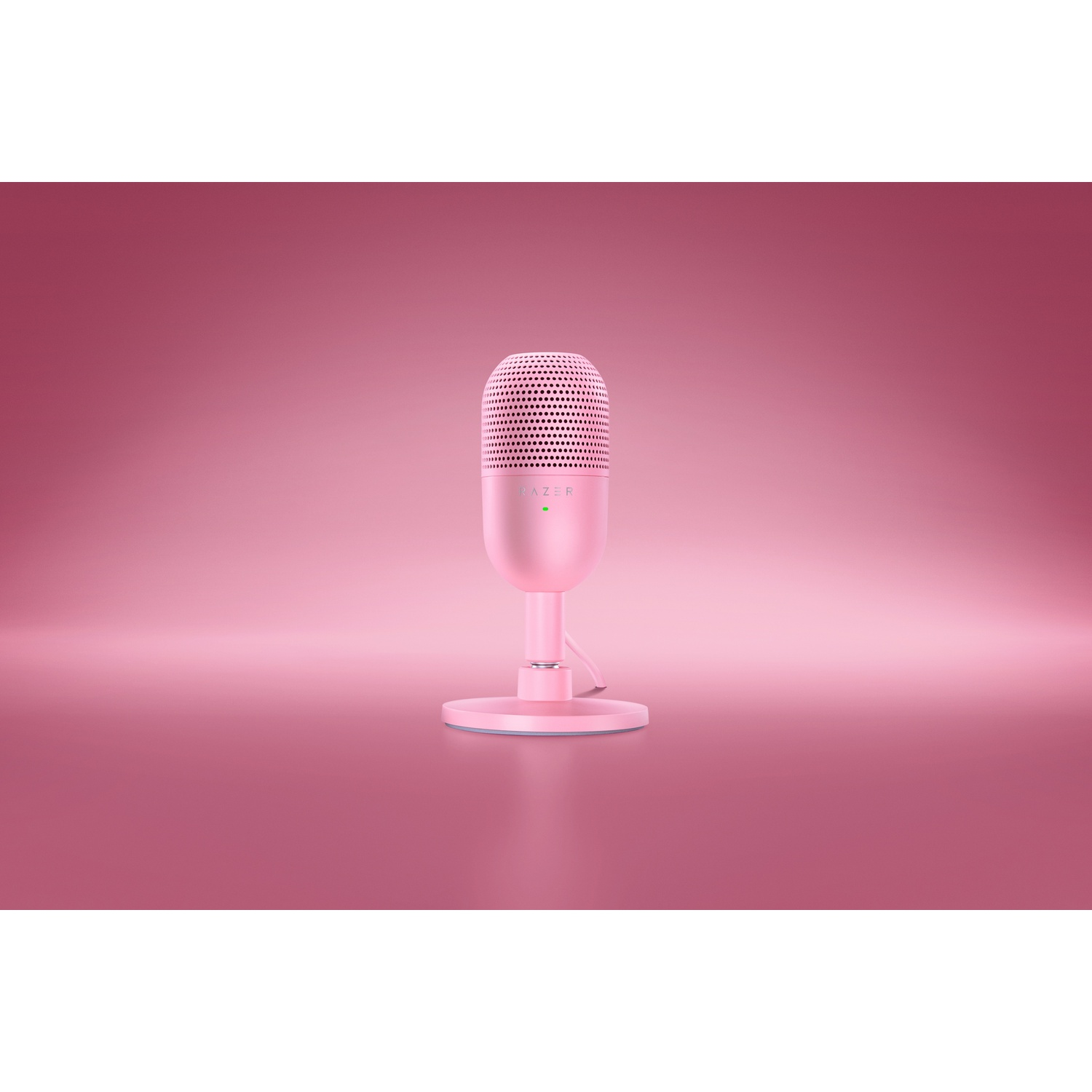 Pink microphone with a round base, on a pink surface with a pink background.