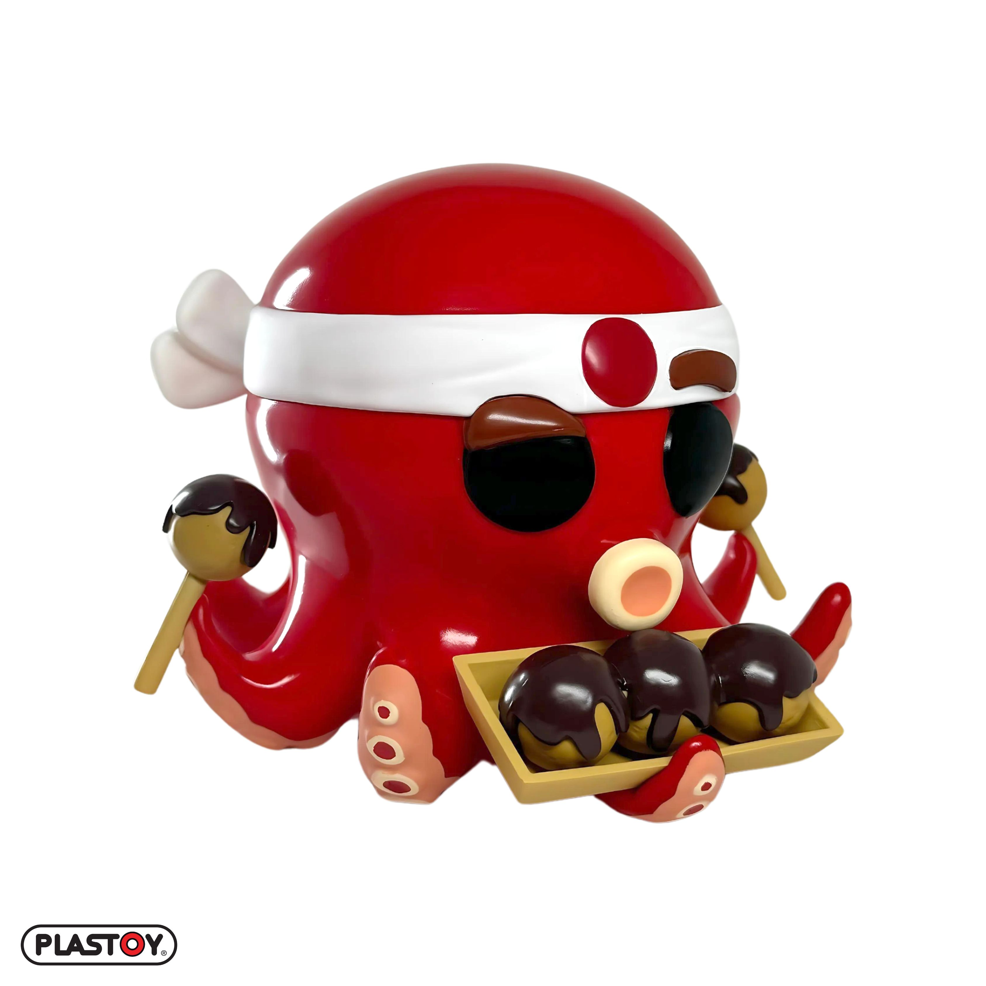 Eine rote, oktopusartige Figur, die Takoyaki-Bälle hält. Sie trägt ein Stirnband.
