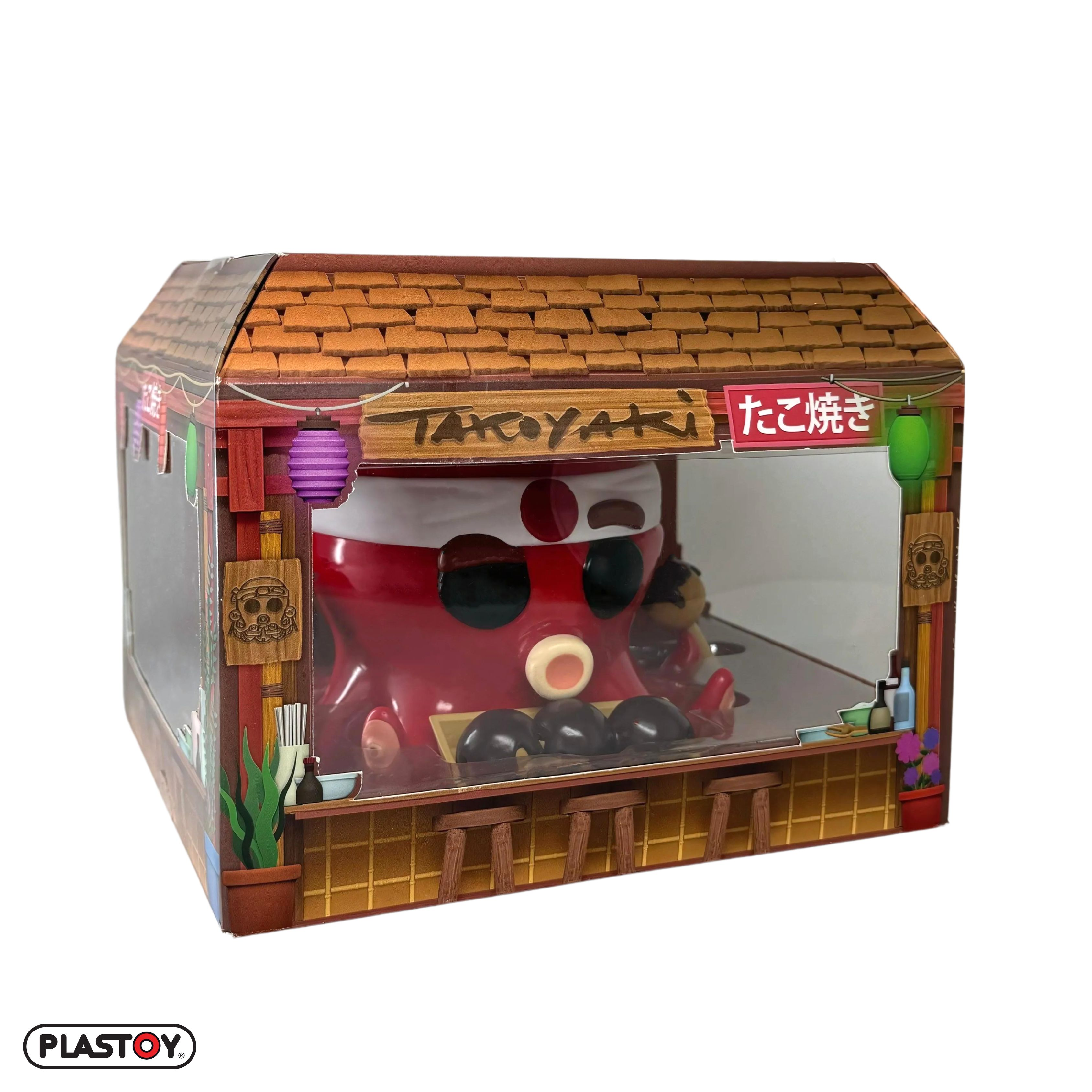 Spielzeugmodell eines Takoyaki-Standes mit roter Oktopus-Figur, weißer Hintergrund.