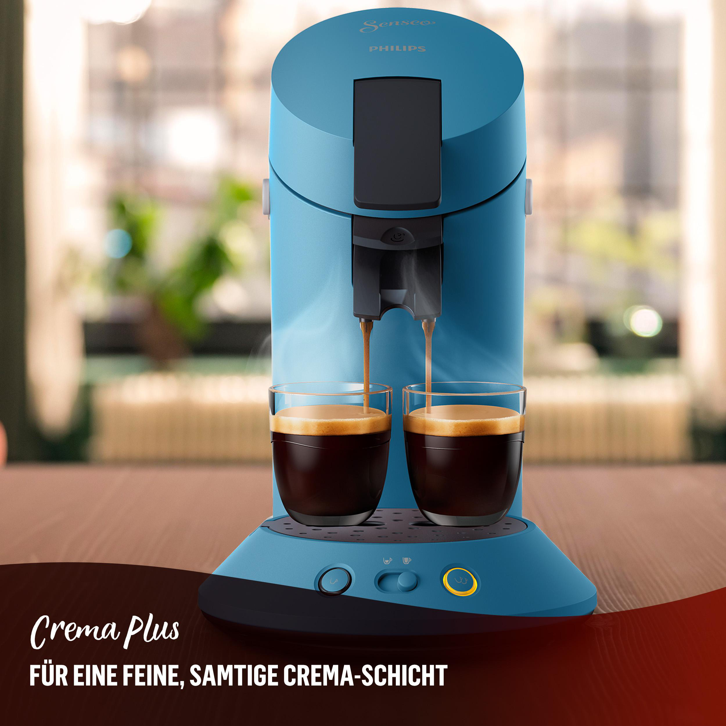 Blaue Kaffeemaschine, die Kaffee in zwei Gläser gießt. Text: 'Crema Plus' und 'Für eine feine, cremige Schicht'.