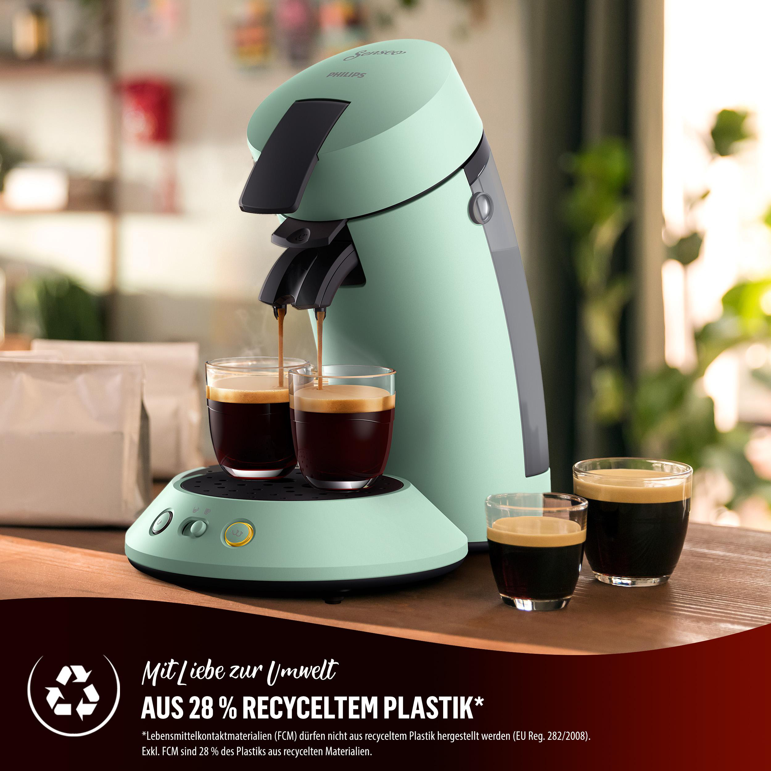 Mintgrüne Philips Senseo Kaffeemaschine mit zwei Kaffeegläsern und Kaffeebohnen.