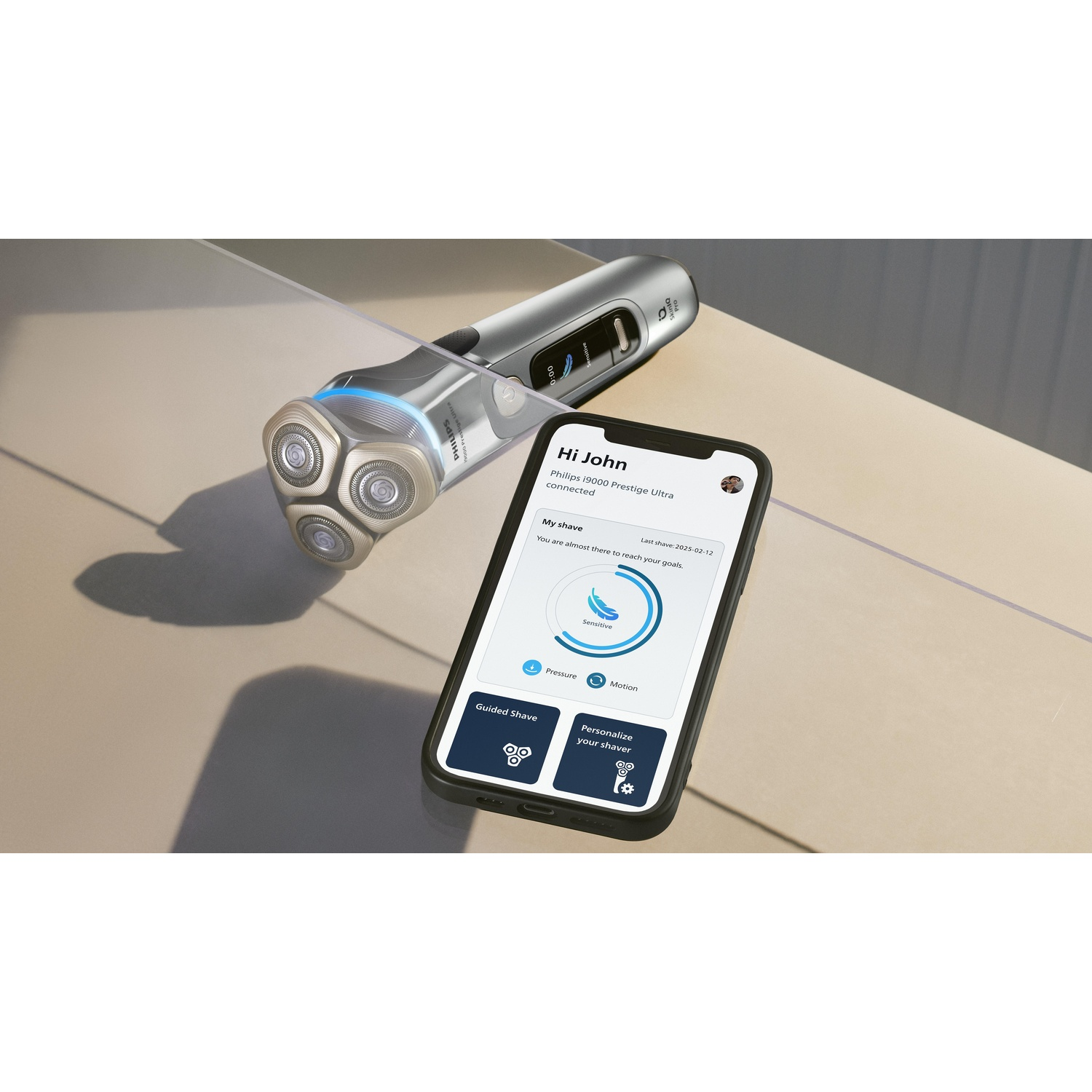 Electric shaver with three heads, and a smartphone displaying an app.