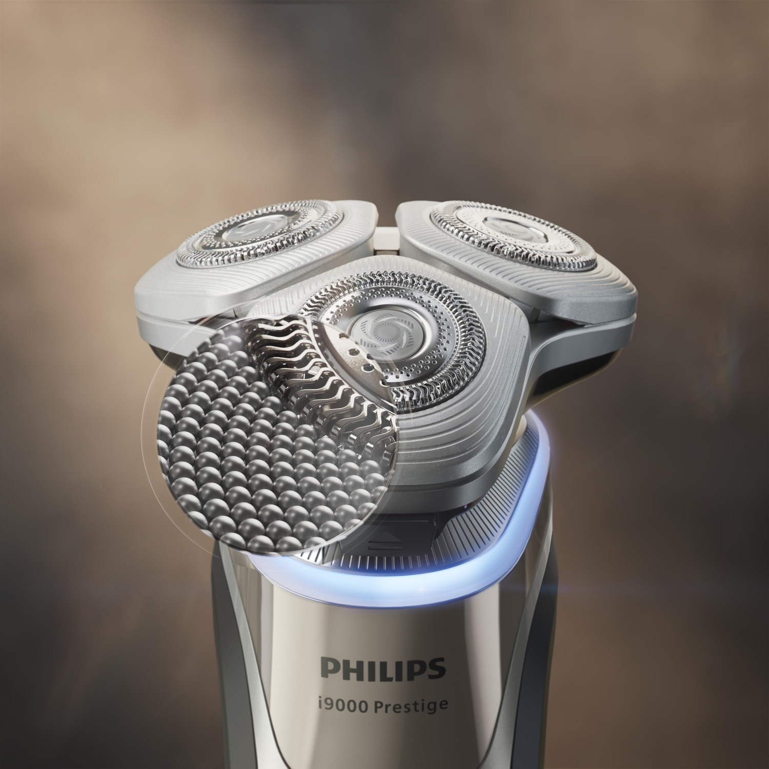 Close up of a Philips shaver. Three shaving heads and a light around the base.