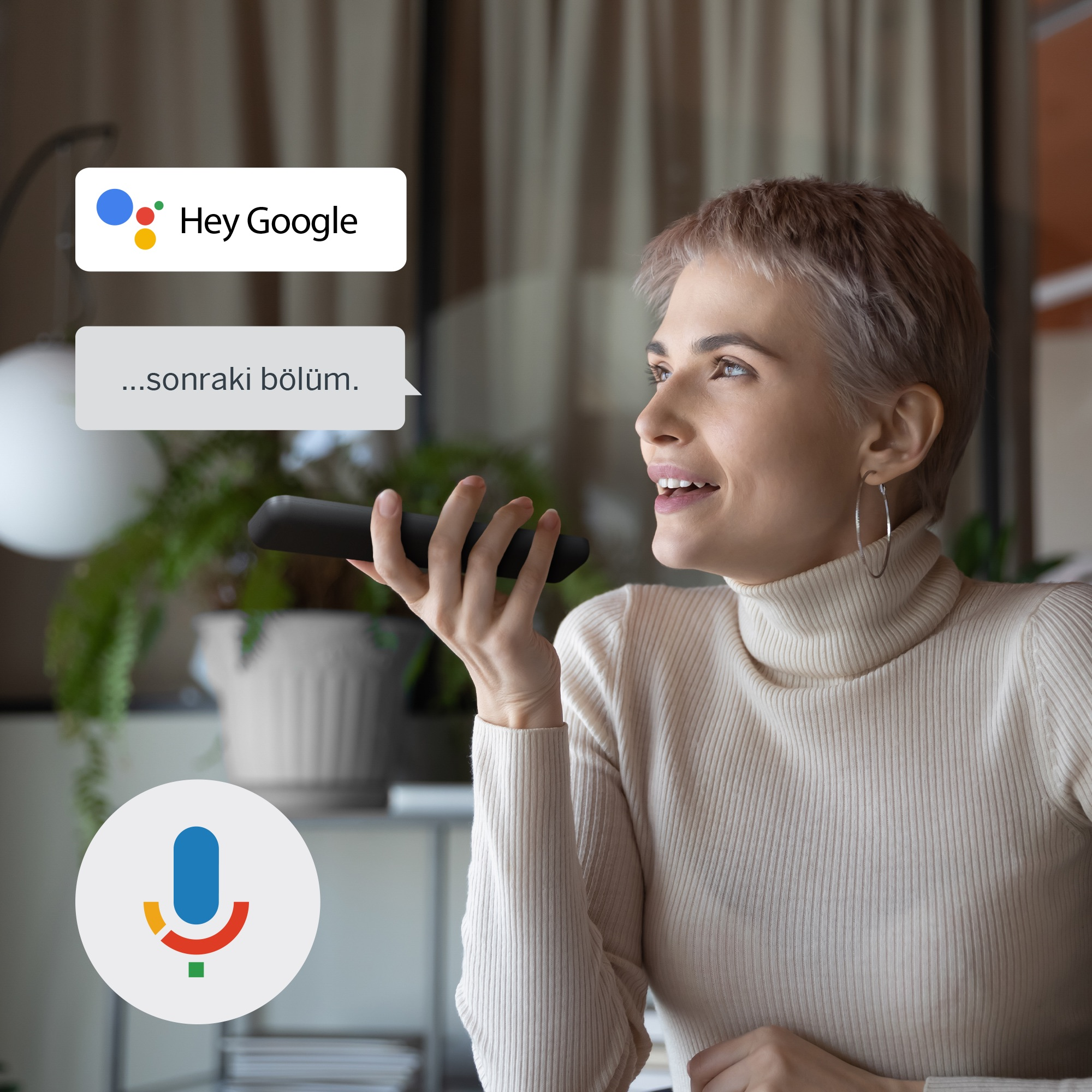 Google Asistan arayüzü olan bir uzaktan kumandaya konuşan kadın.