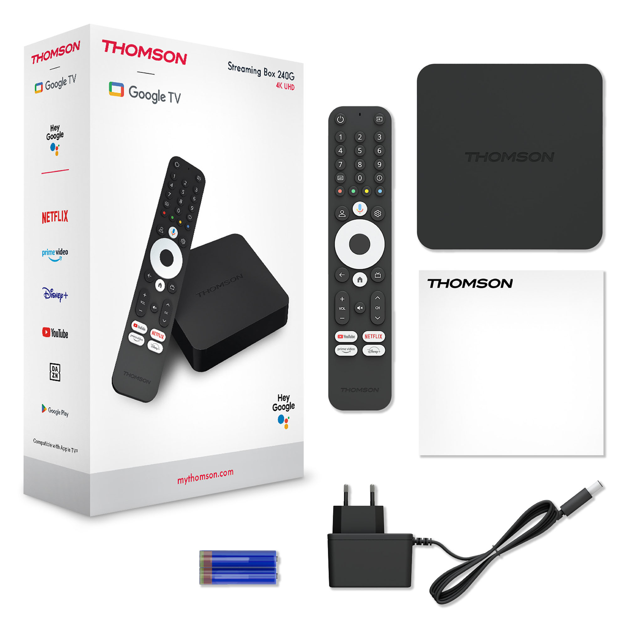 Thomson Google TV kutusu, uzaktan kumanda, şarj cihazı ve aksesuarlar beyazda.