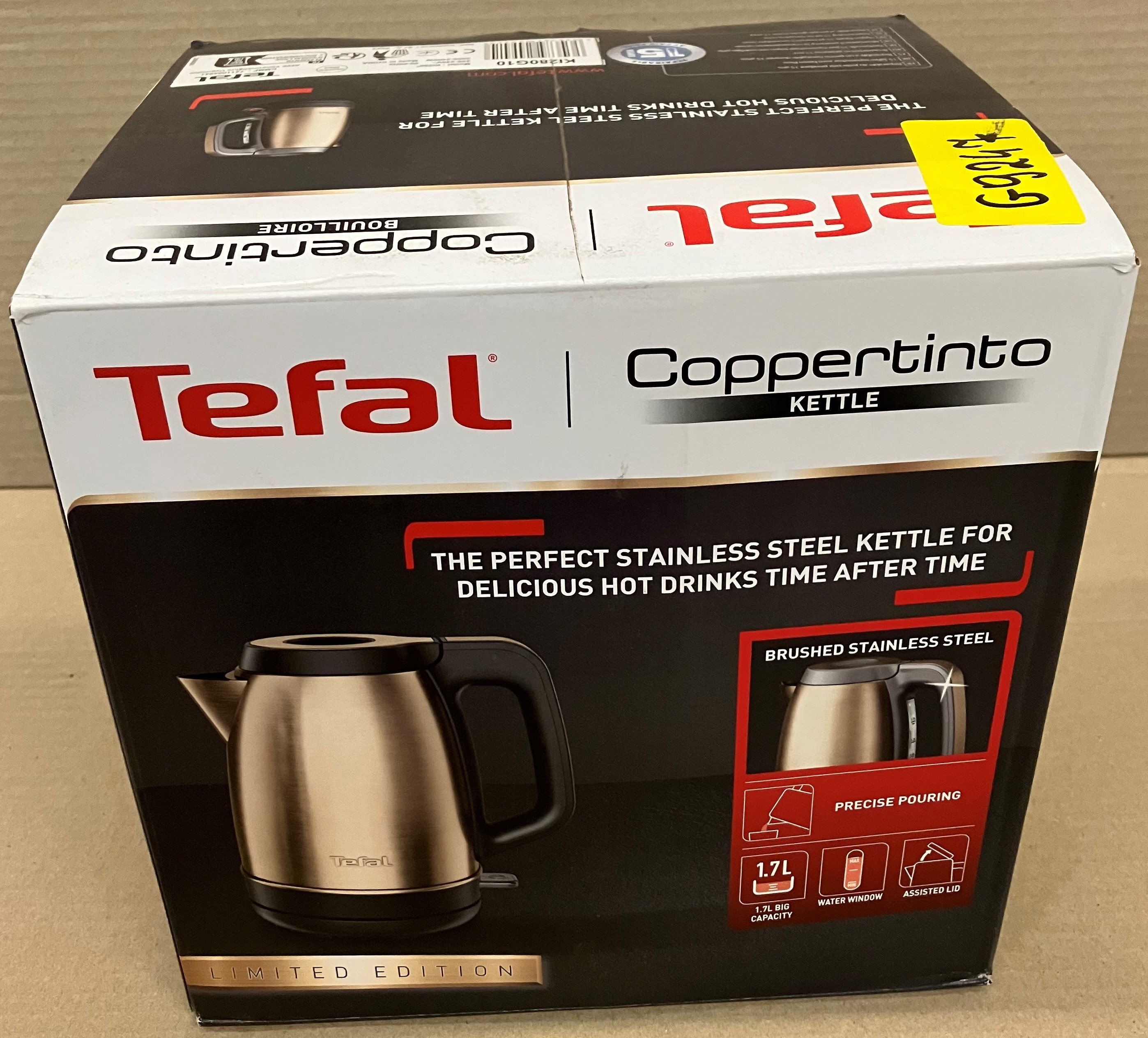 Złoty i czarny czajnik Tefal w pudełku z informacjami o produkcie.