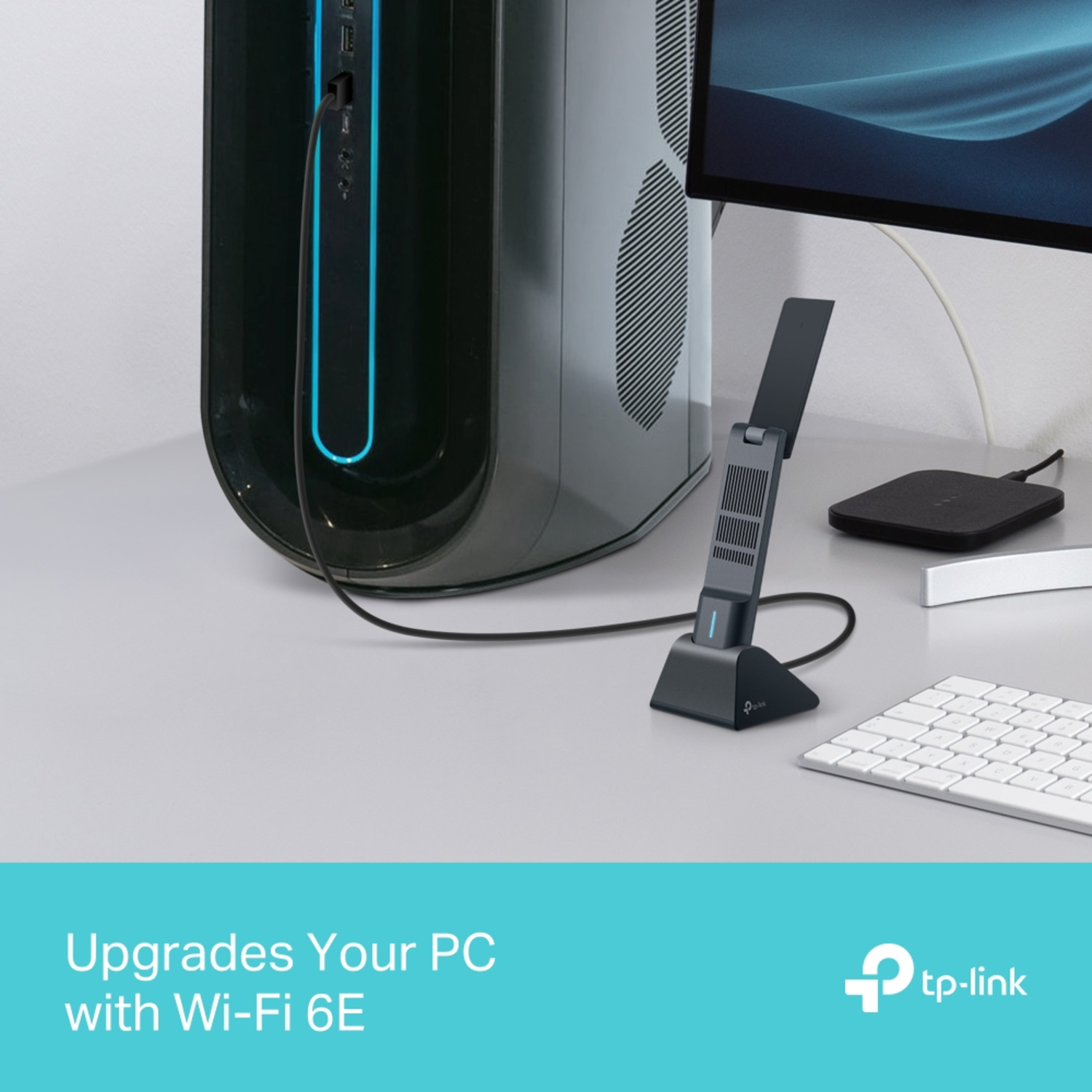 A black desktop computer with a WiFi adapter, keyboard, and monitor on a gray desk. Text reads, 'Upgrades Your PC with Wi-Fi 6E'.