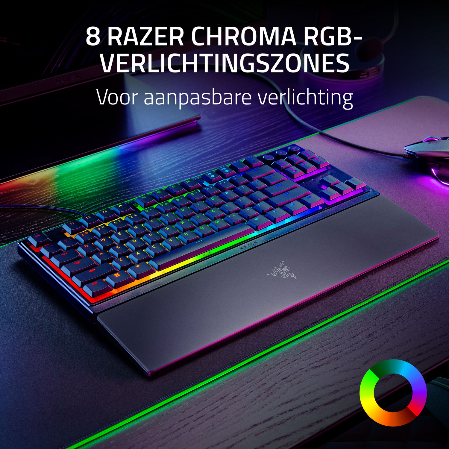 A keyboard with colorful lights and a wrist rest on a desk.