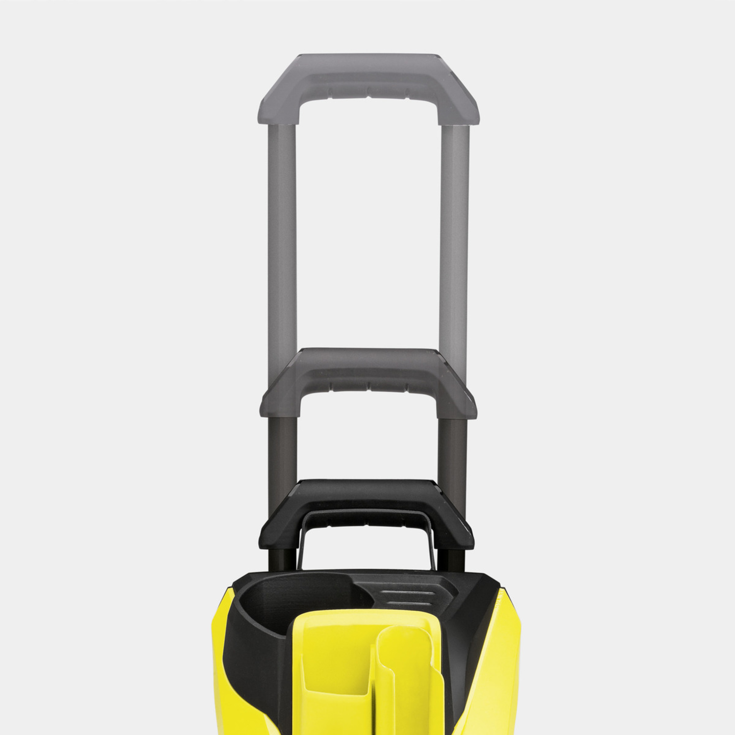 Une machine de nettoyage jaune et noire avec une poignée étendue vers le haut.