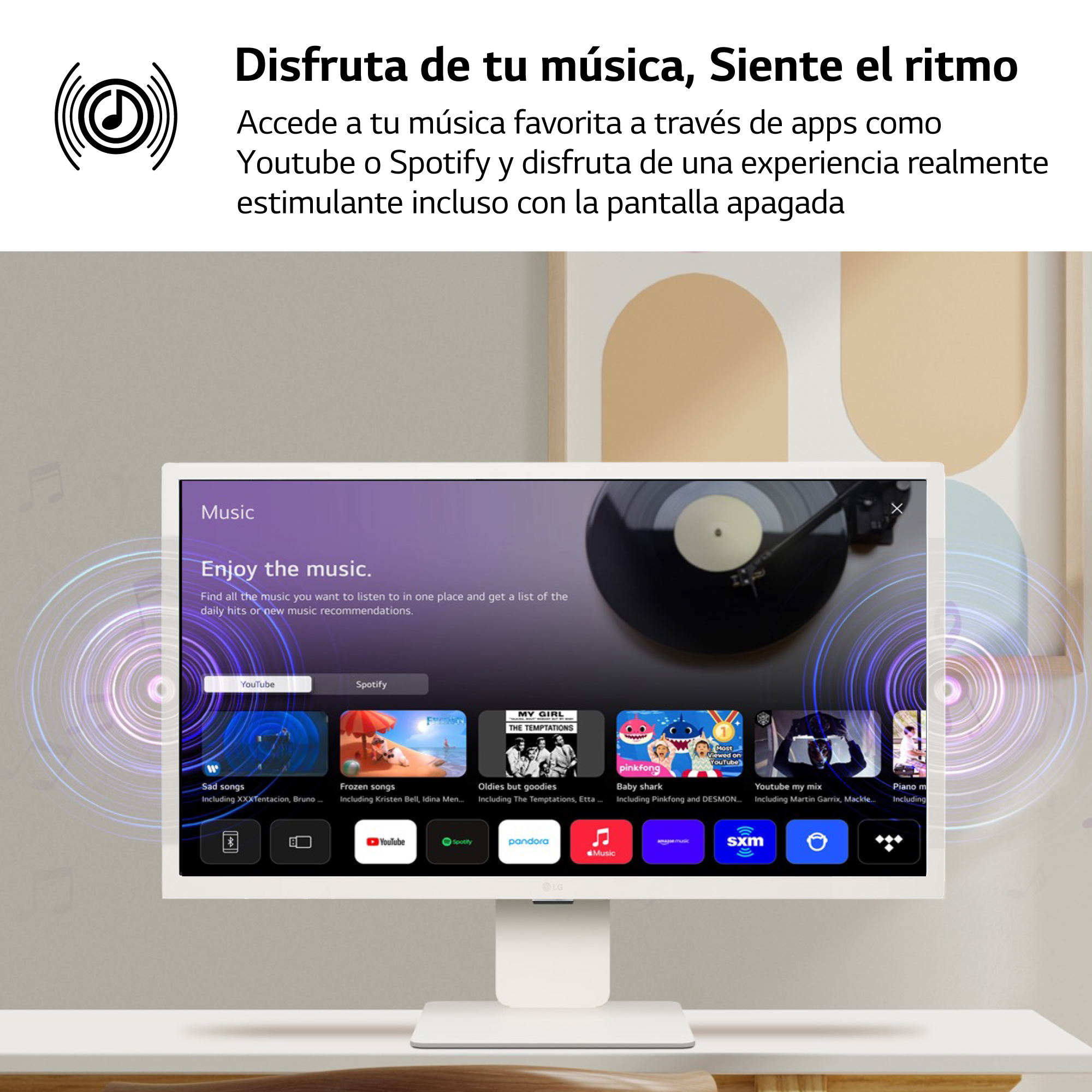 Un monitor de computadora muestra una interfaz de aplicación de música. Varias portadas de álbumes son visibles.
