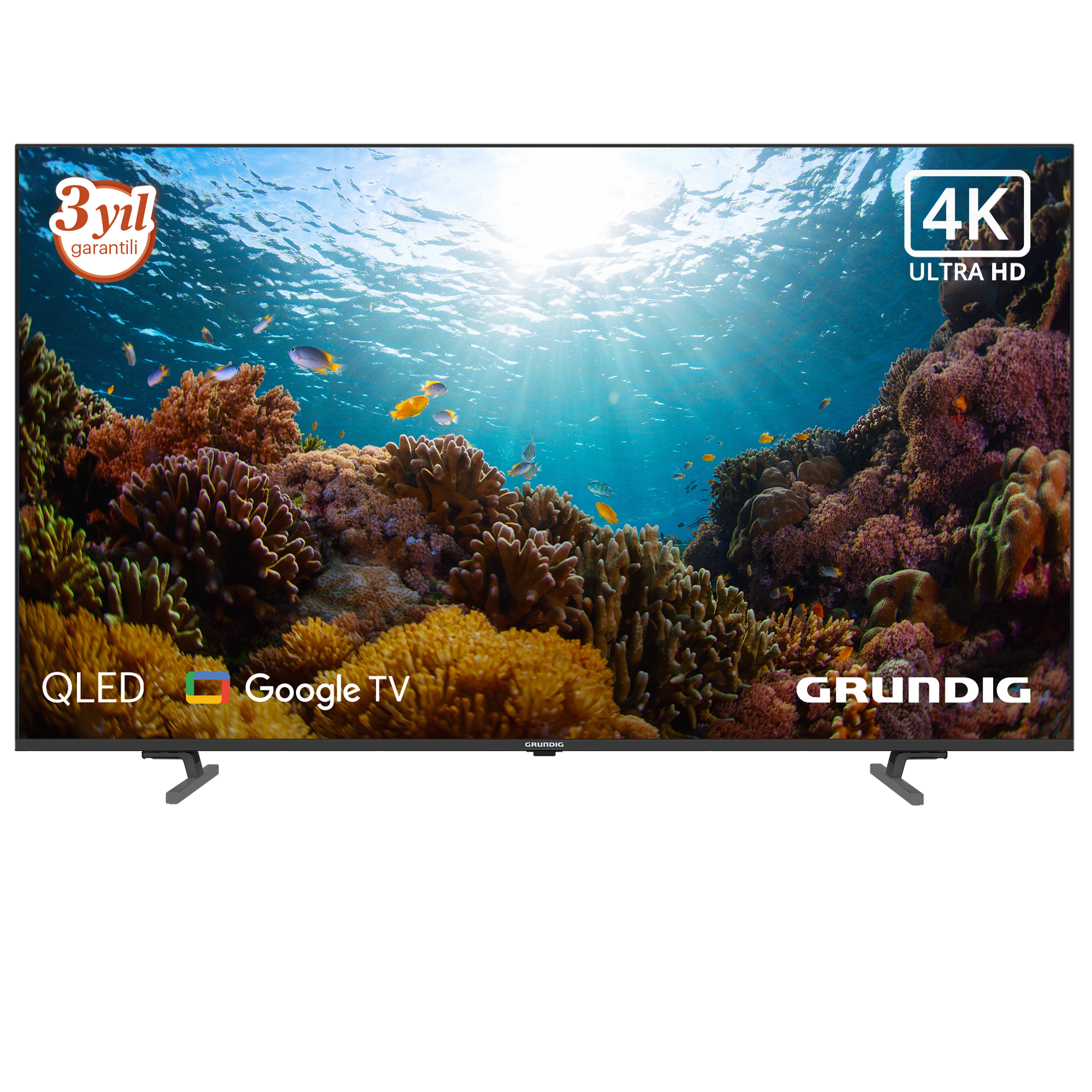 Su altı mercan kayalığı sahnesi gösteren bir Grundig QLED 4K Ultra HD TV. 3 yıl garanti ve Google TV etiketleri.