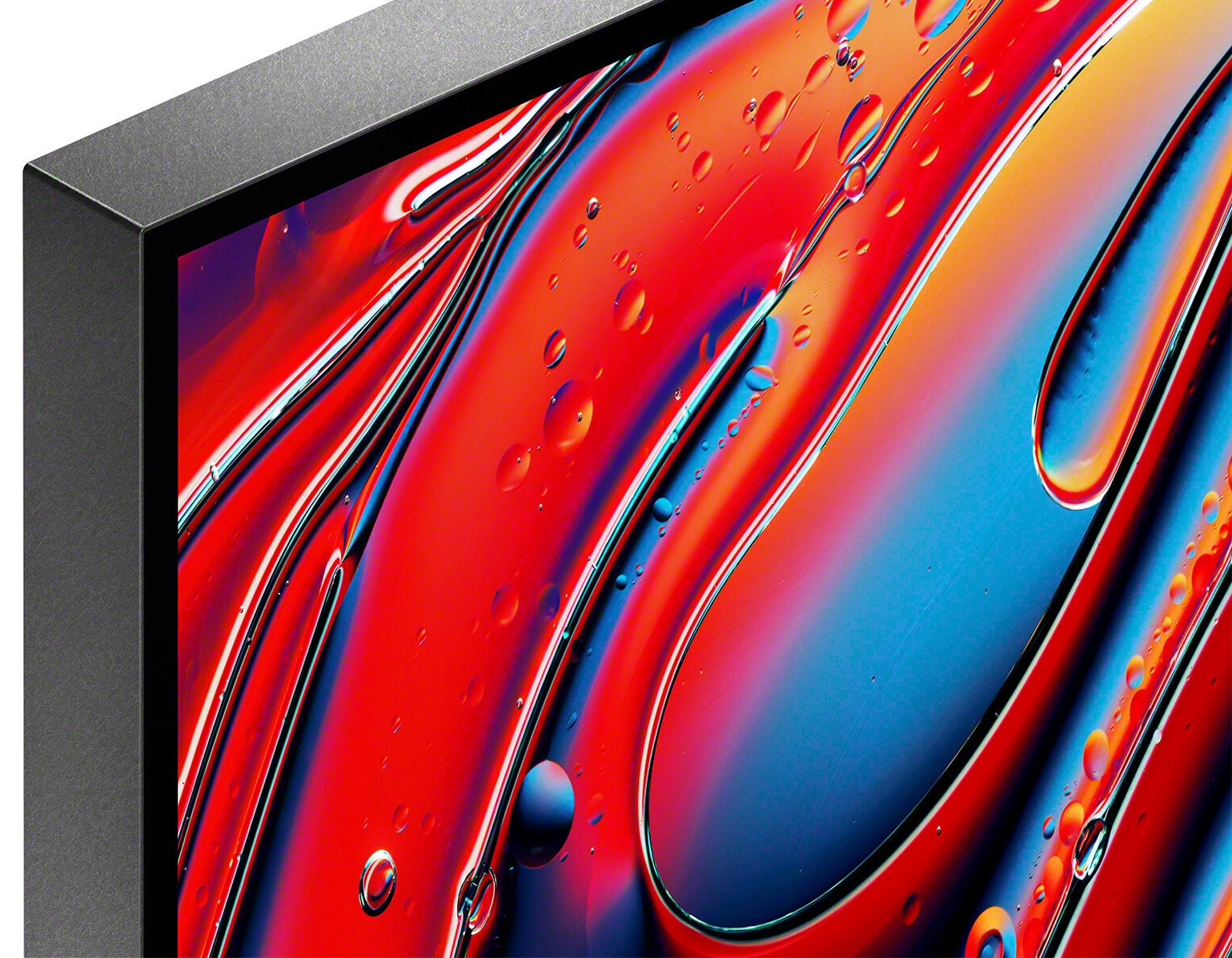 Zbliżenie ekranu wyświetlającego abstrakcyjną sztukę z czerwonymi, niebieskimi i żółtymi wzorami płynów.