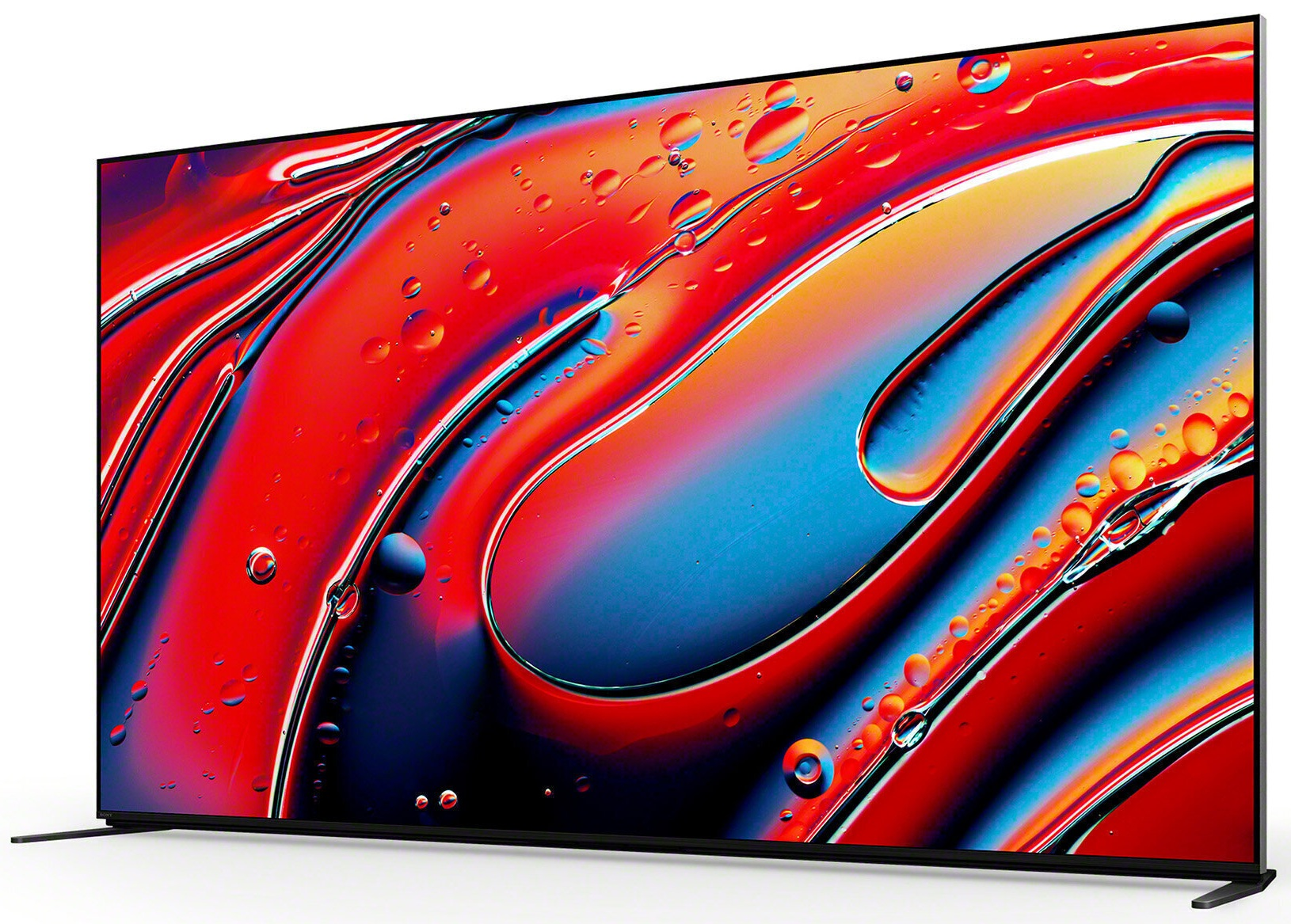 Duży ekran telewizora z żywym abstrakcyjnym wzorem w kolorach czerwonym, niebieskim i żółtym, krople wody.