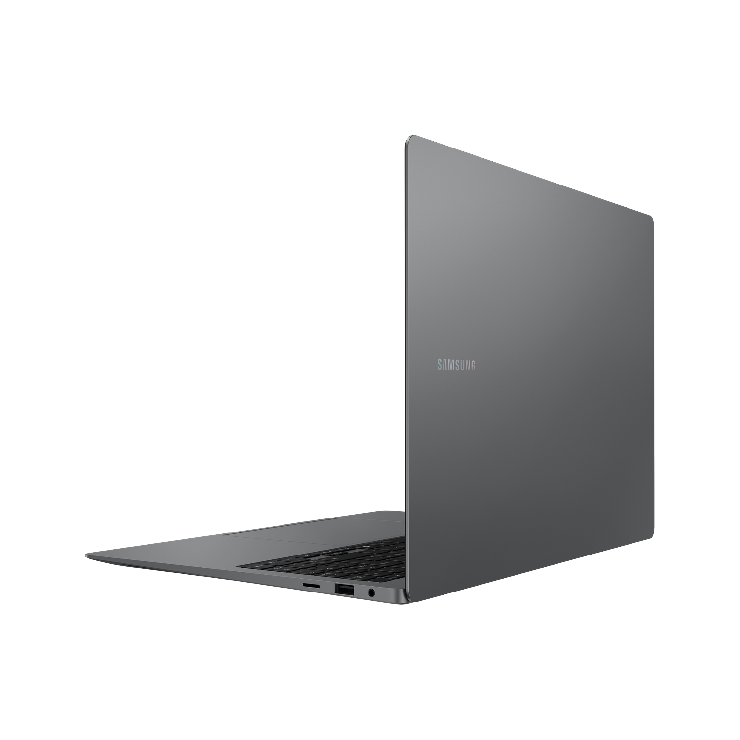 Una laptop Samsung gris oscuro está abierta y en ángulo, sobre un fondo negro.