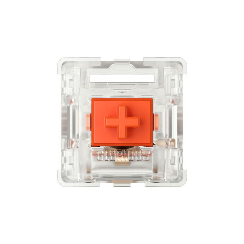 Ein klarer Schalter mit einem orangefarbenen kreuzförmigen Schaft und dem Wort 'GLORIOUS'.