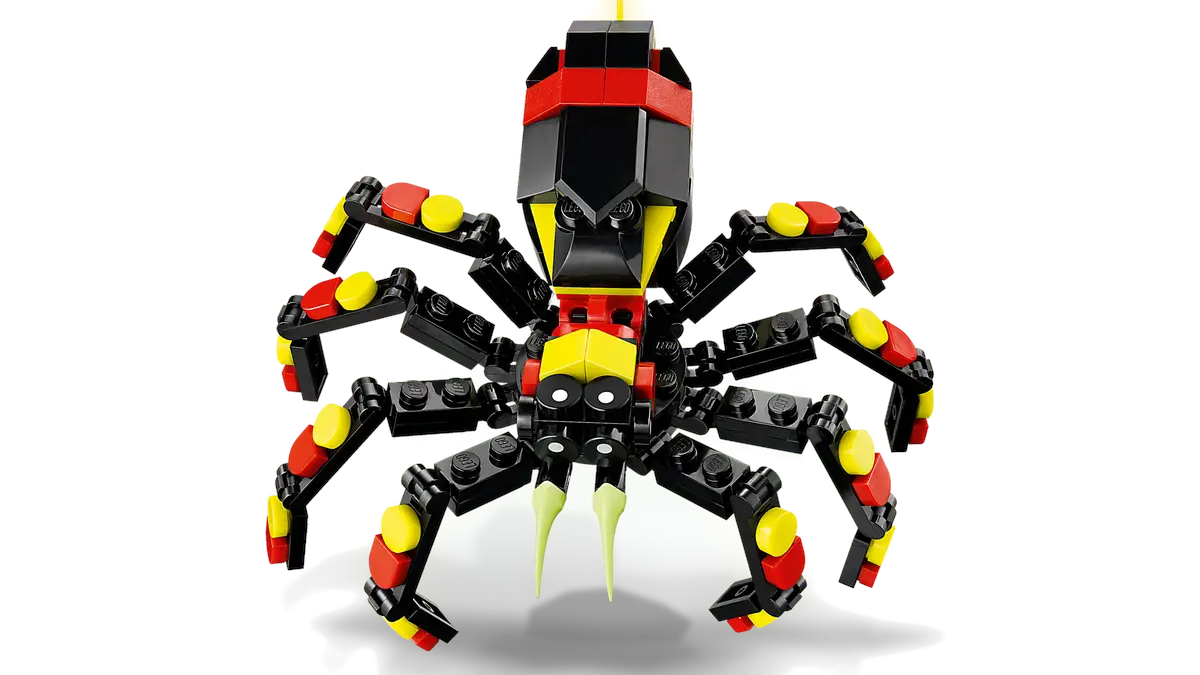 Model skorpiona LEGO. Czarny korpus, żółte i czerwone akcenty. Zielony kolec. Czarne tło.