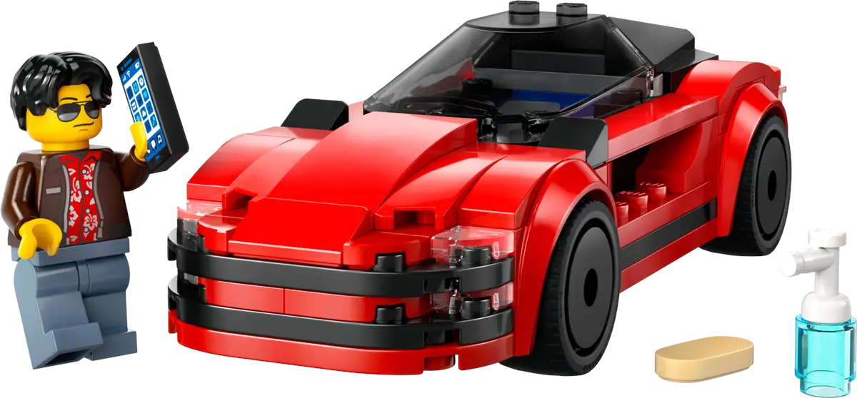 Figurka Lego trzymająca telefon, czerwony samochód sportowy i inne akcesoria na czarnym tle.