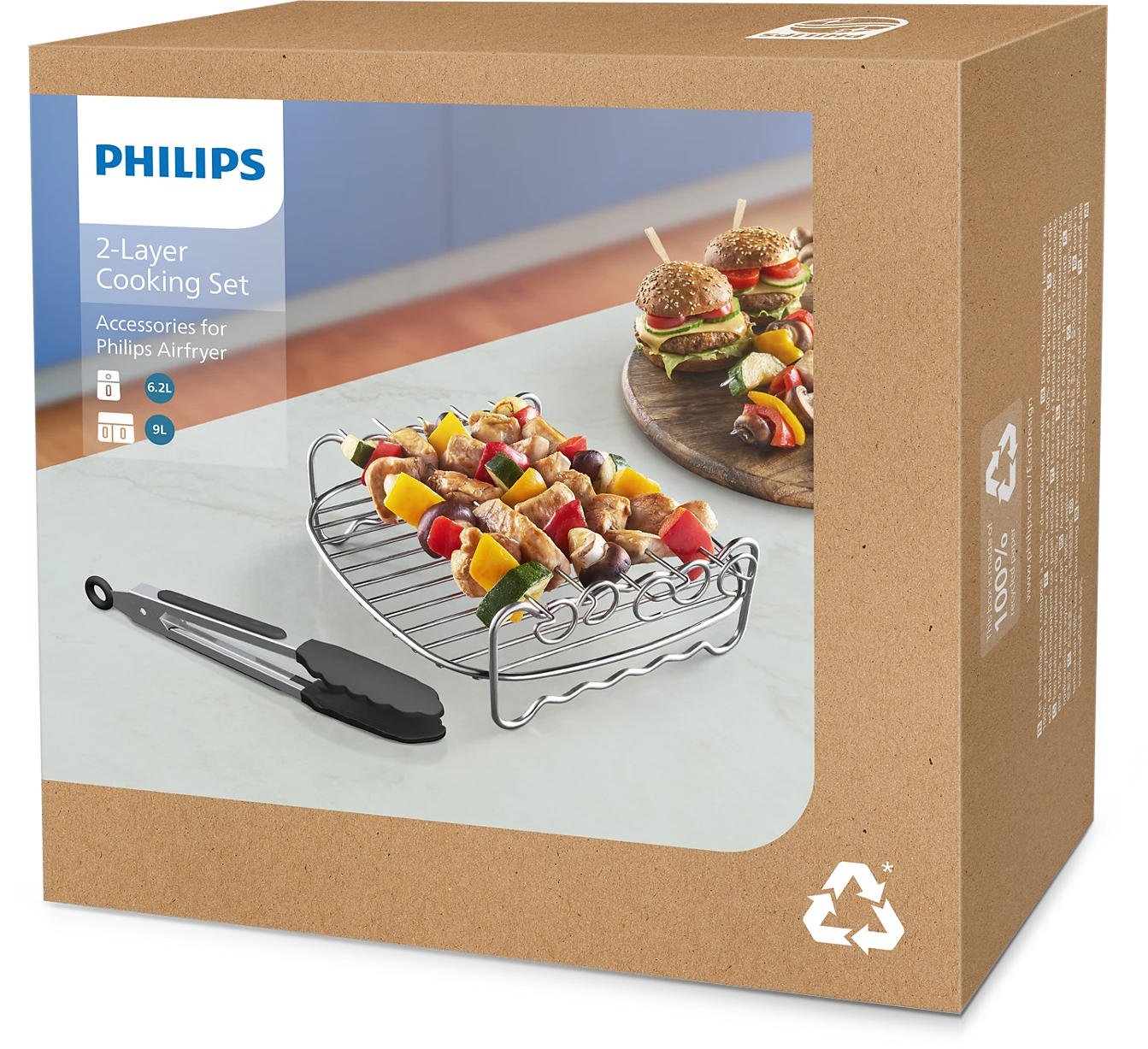 Box mit einem 2-Schicht-Kochset mit Spießen und Zangen. Lebensmittel- und Produktbilder sind sichtbar.