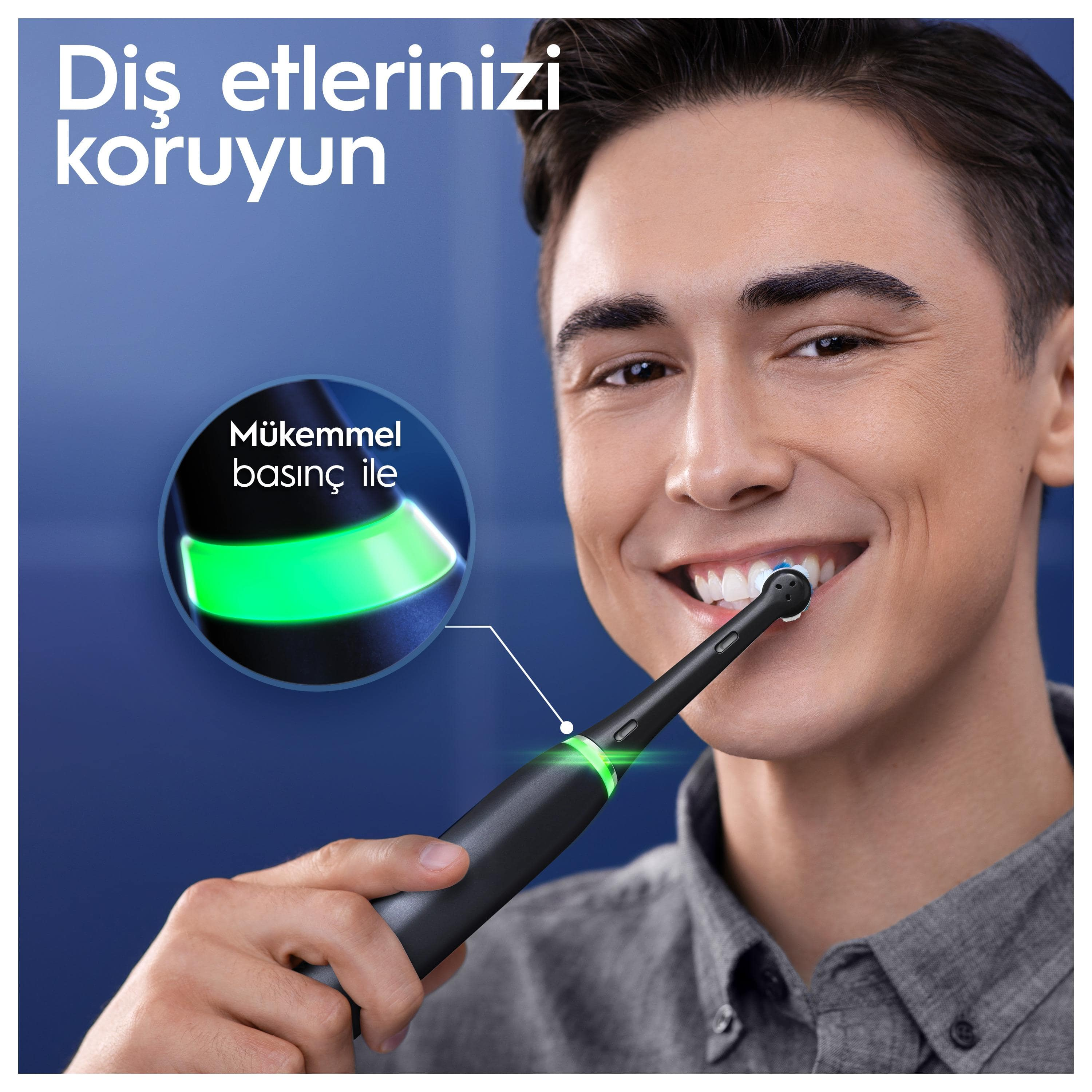Basıncı ve dişleri vurgulayarak, elektrikli diş fırçasıyla dişlerini fırçalayan adam.