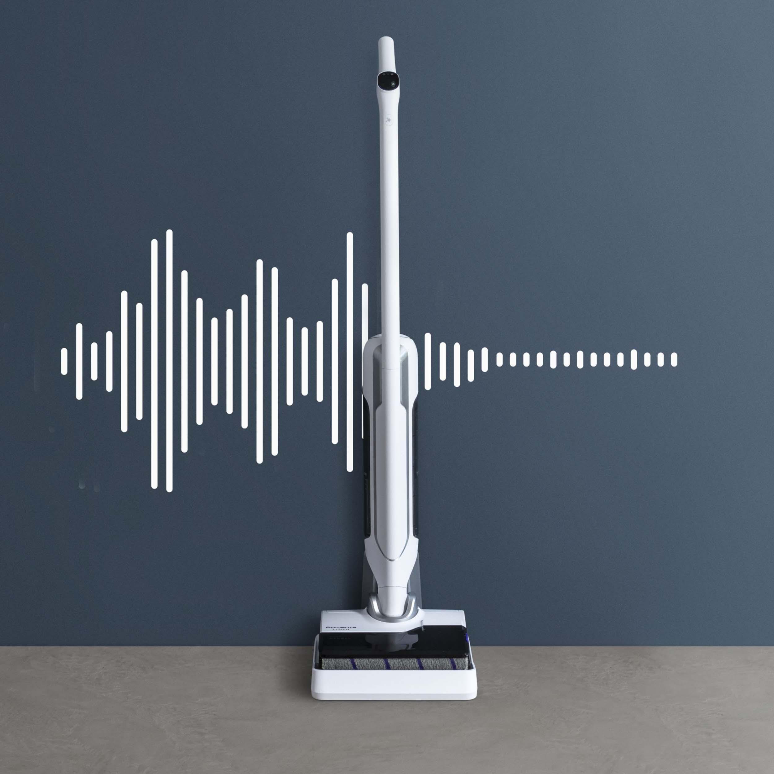 Weißer kabelloser Staubsauger an grauer Wand mit Schallwellen-Grafik. Modernes, sauberes Design.