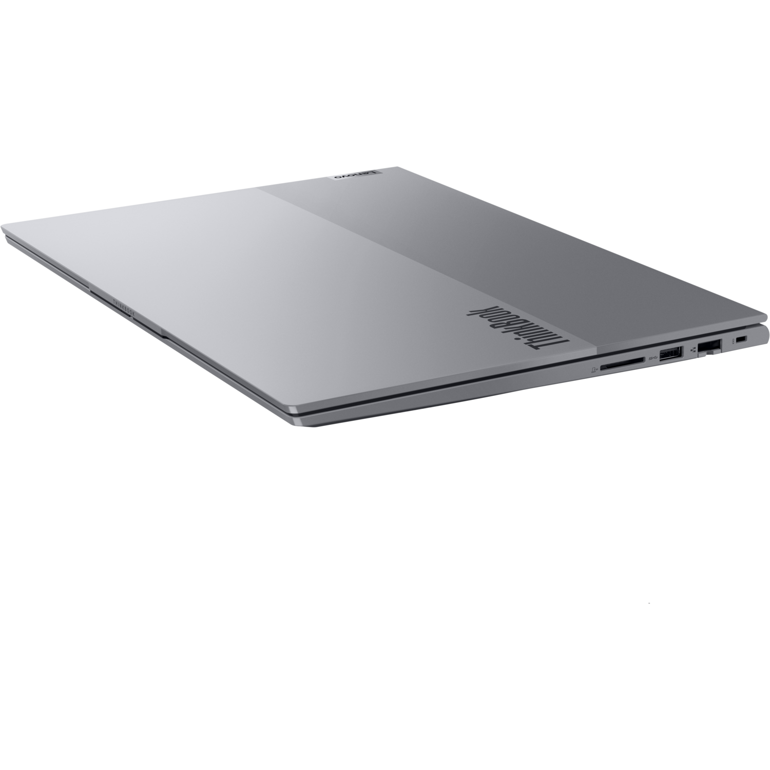 Zilveren gesloten laptop op een zwart oppervlak, met ThinkBook-logo.
