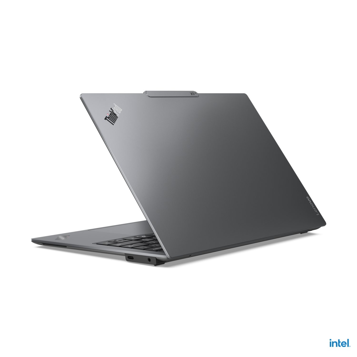 A grey Lenovo laptop with the ThinkPad logo open on a black background.