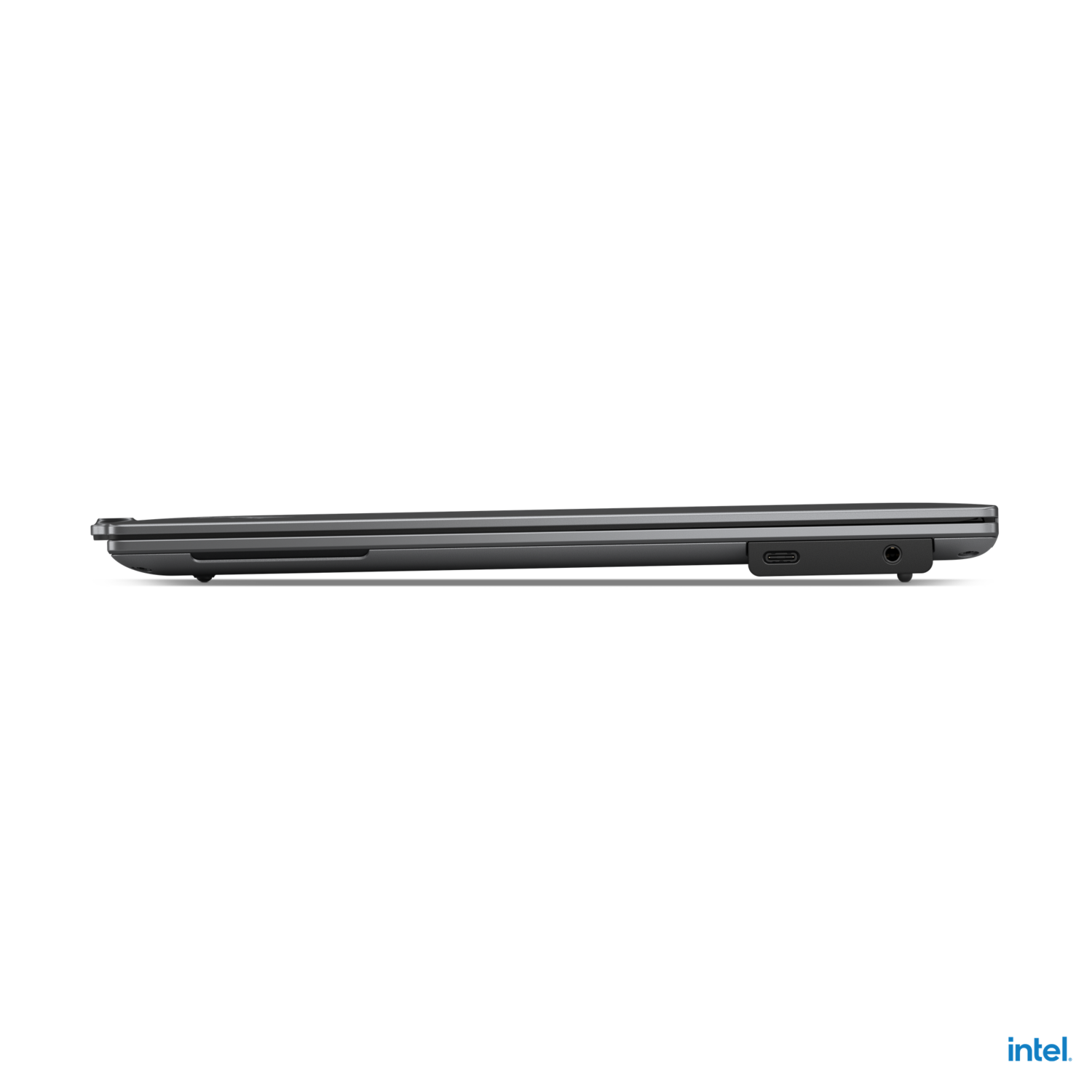 Side view of a closed, grey laptop against a black background.