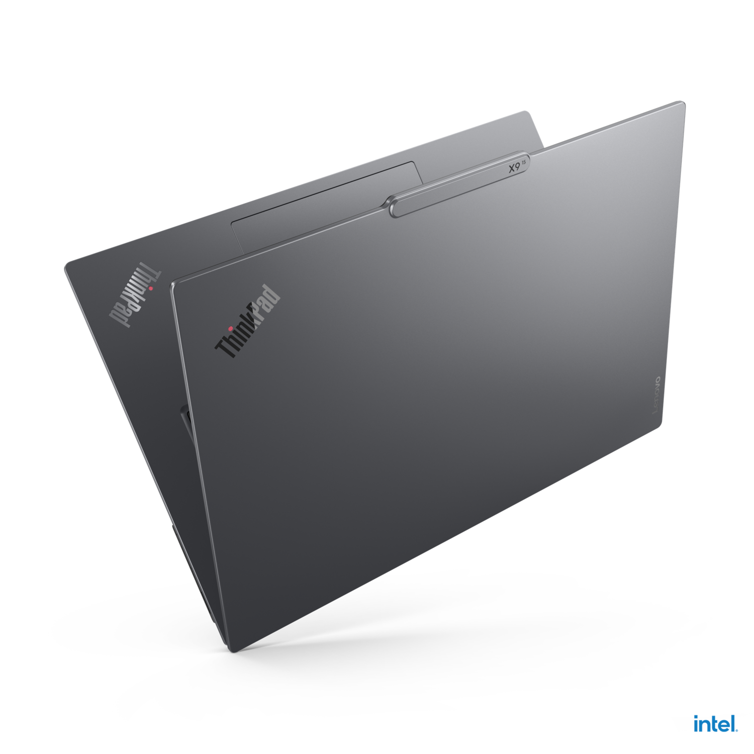 The back and top of a dark gray laptop. The Lenovo and ThinkPad logos are visible.