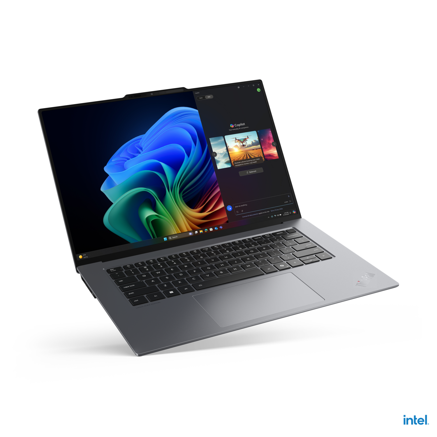 A dark gray laptop open, showing a Windows interface. The Intel logo is visible.