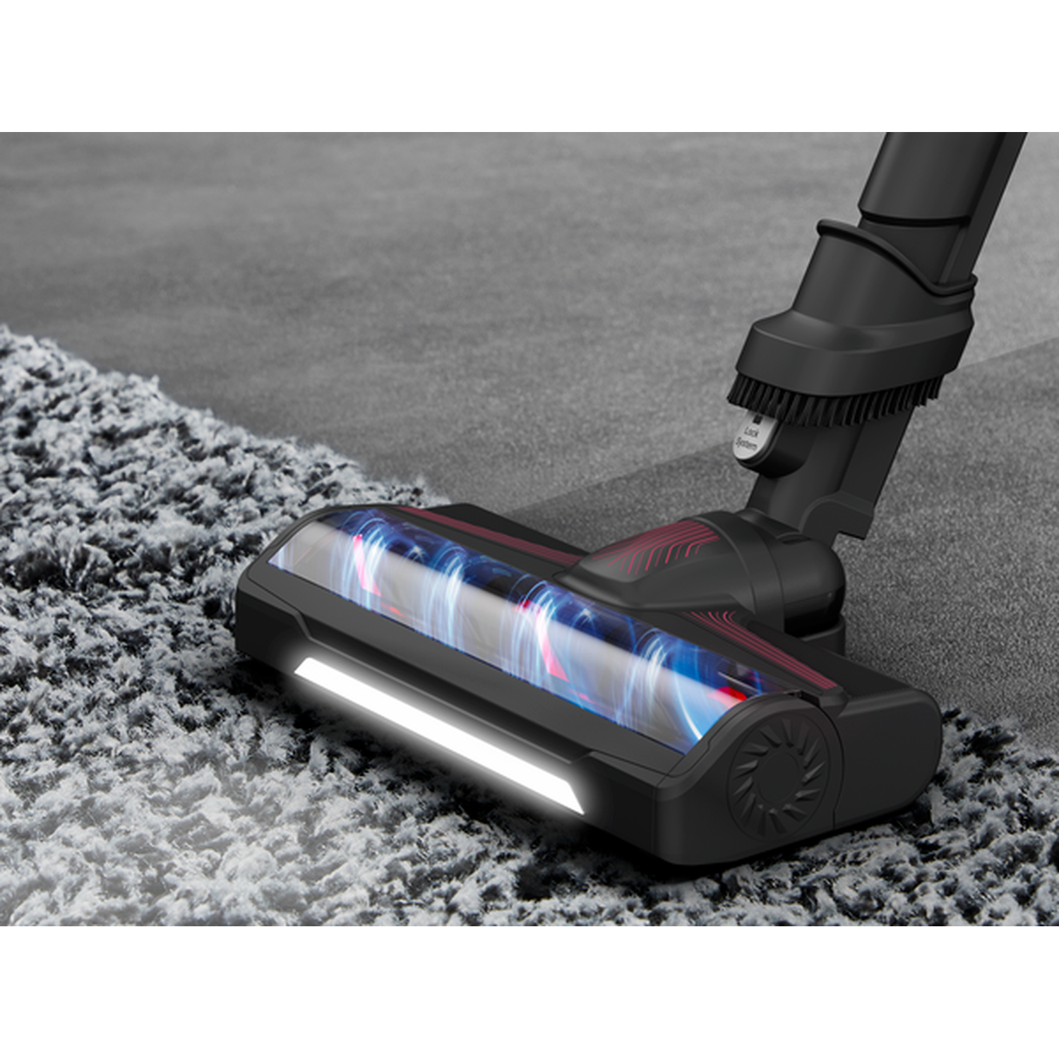 Vacuum cleaner brush head close-up on carpet, showing lights and rotating brush. Gray carpet.